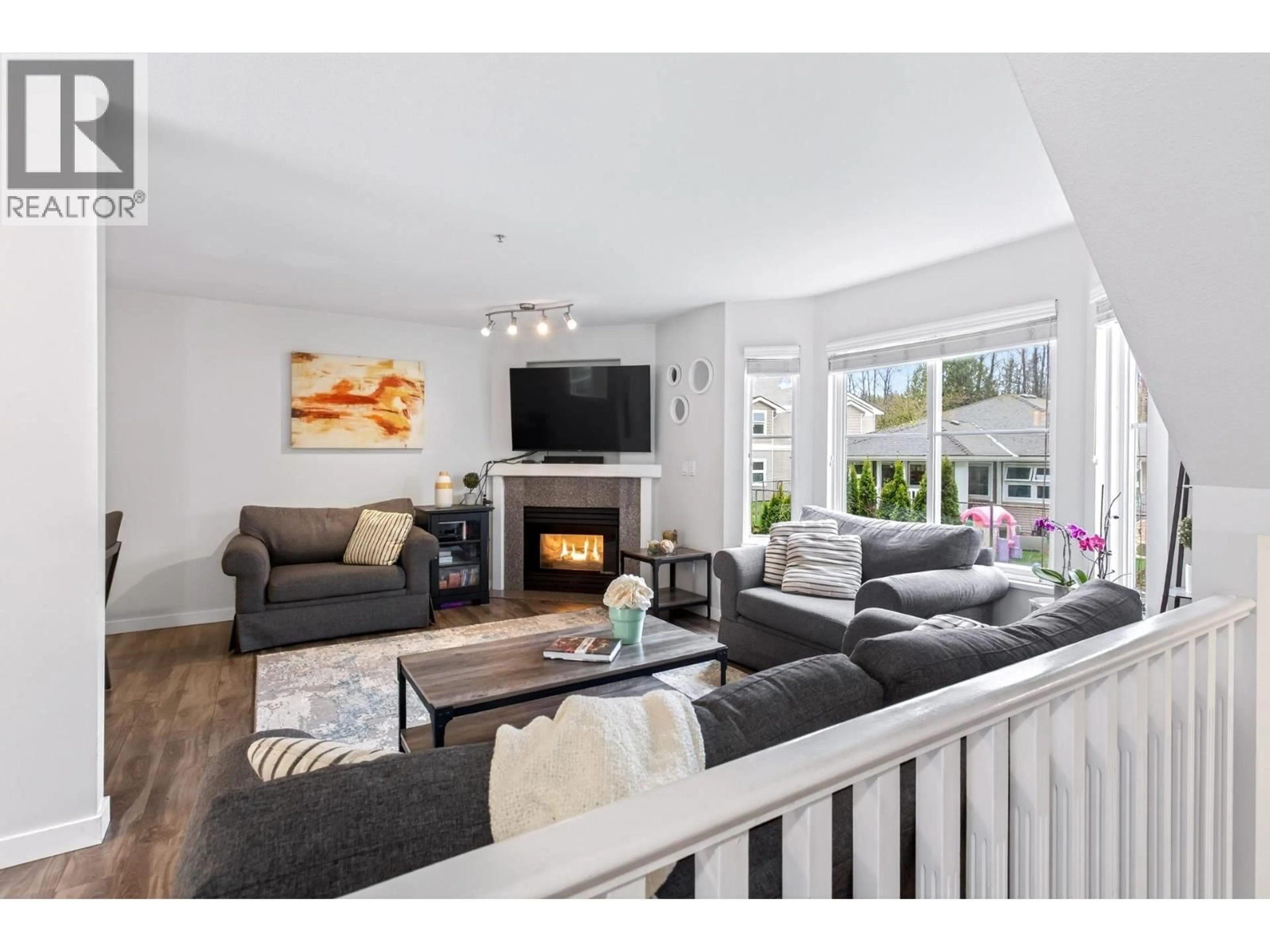 Living room with furniture, wood/laminate floor for 20 - 2458 PITT RIVER ROAD, Port Coquitlam British Columbia V3C6J7