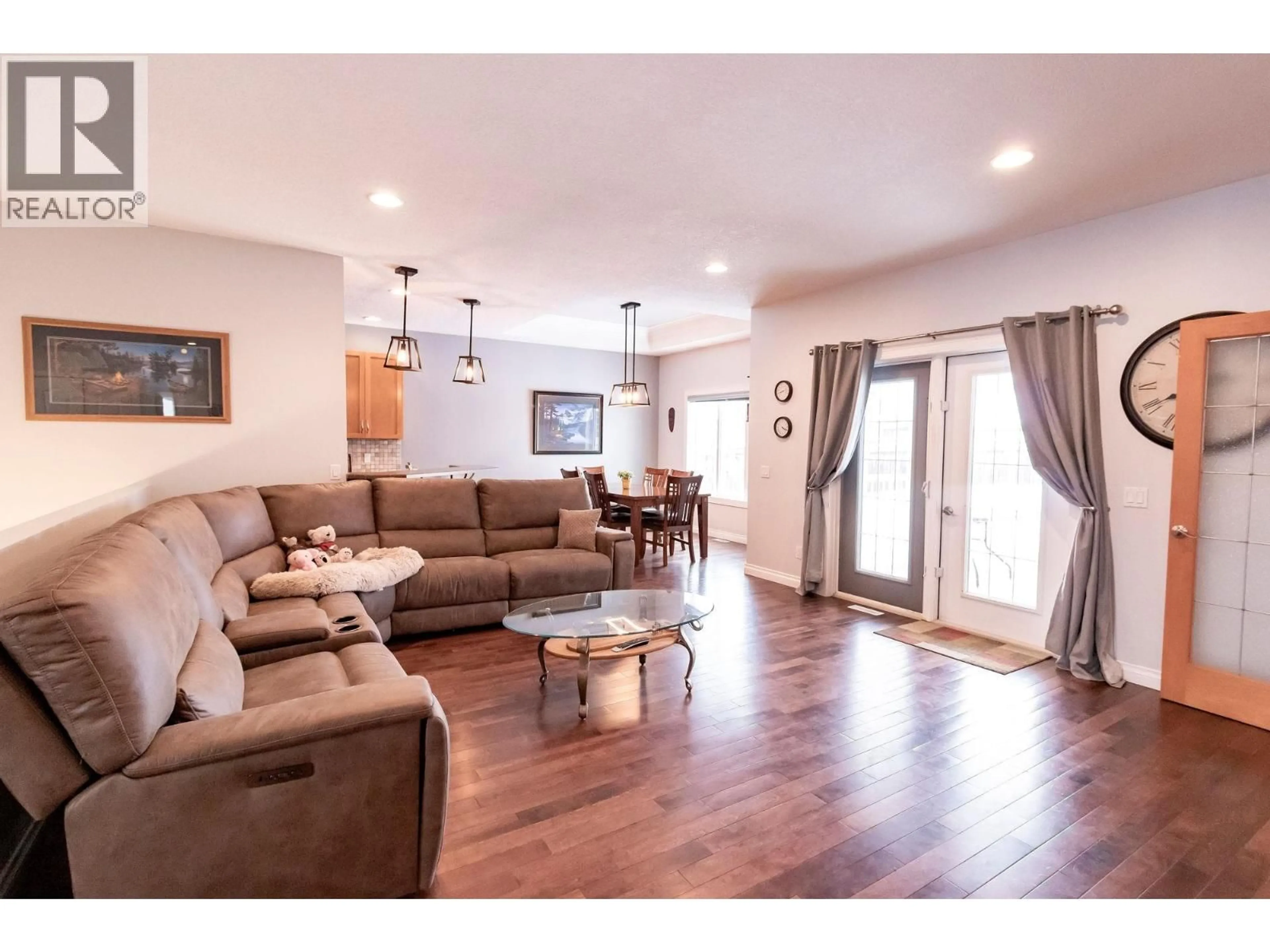 Living room with furniture, wood/laminate floor for 11007 88A STREET, Fort St. John British Columbia V1J7G2