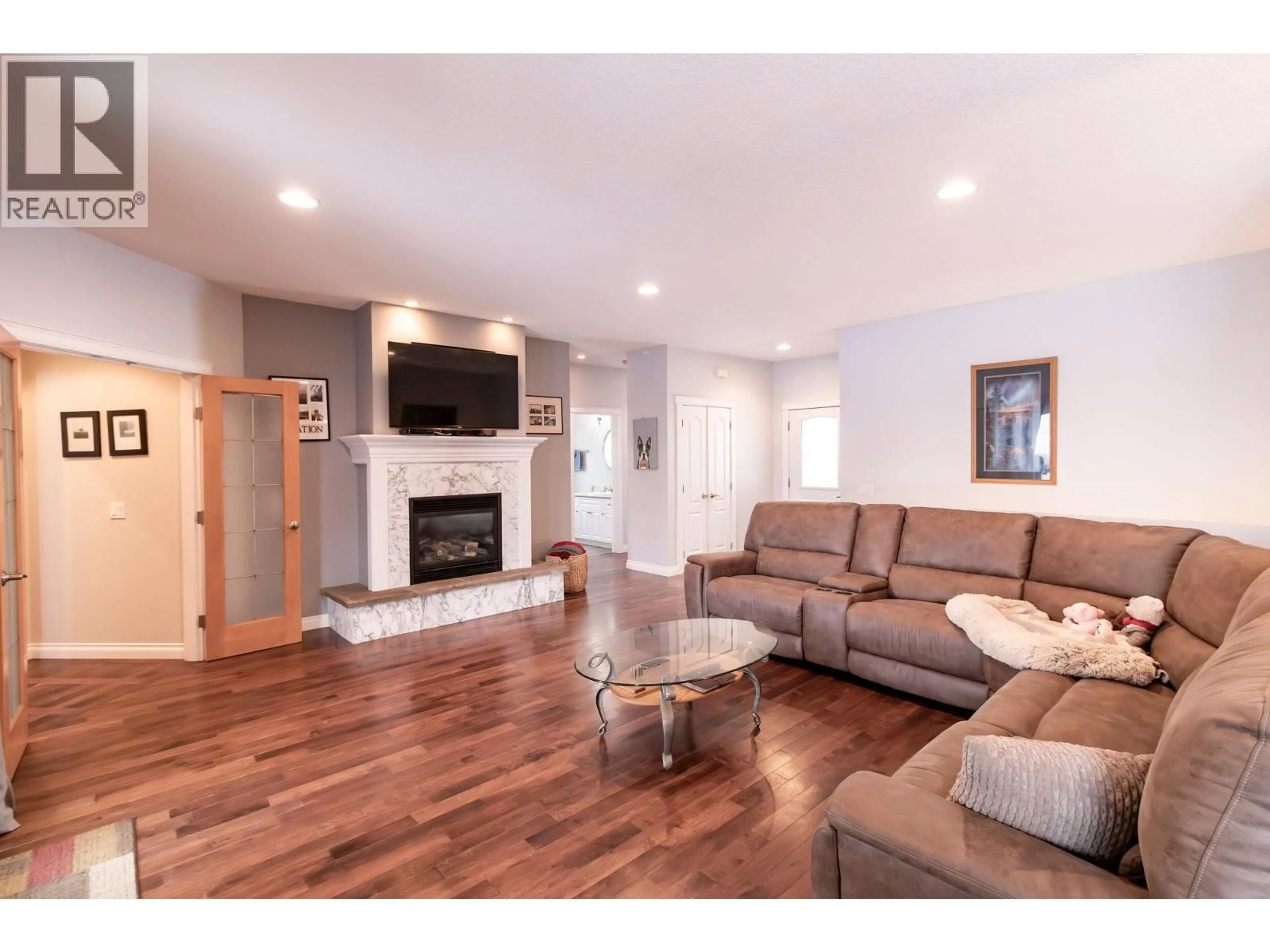 Living room with furniture, wood/laminate floor for 11007 88A STREET, Fort St. John British Columbia V1J7G2