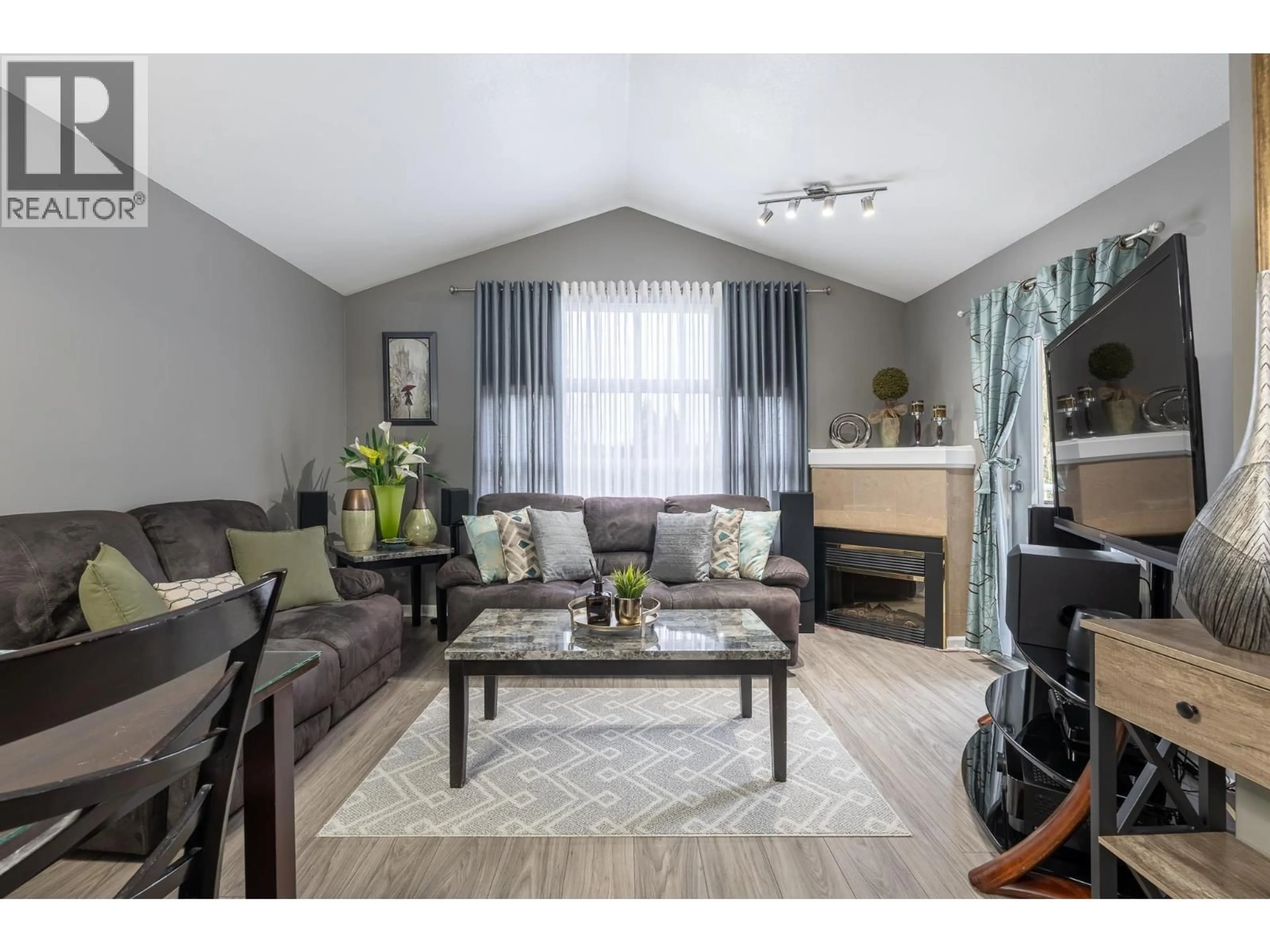 Living room with furniture, wood/laminate floor for 310 - 5355 BOUNDARY ROAD, Vancouver British Columbia V2T0G9