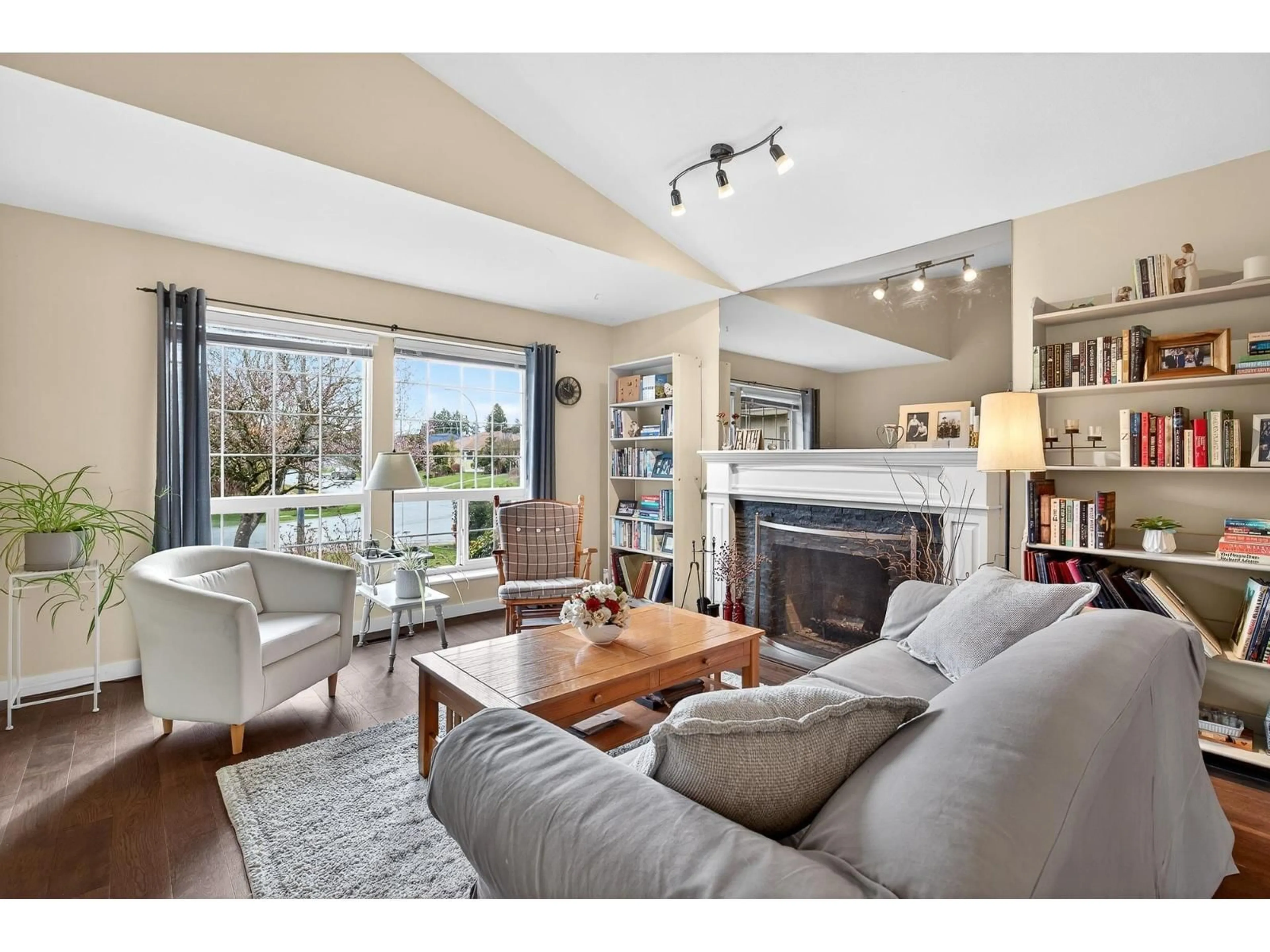 Living room with furniture, wood/laminate floor for 4851 208A STREET, Langley British Columbia V3A5X9