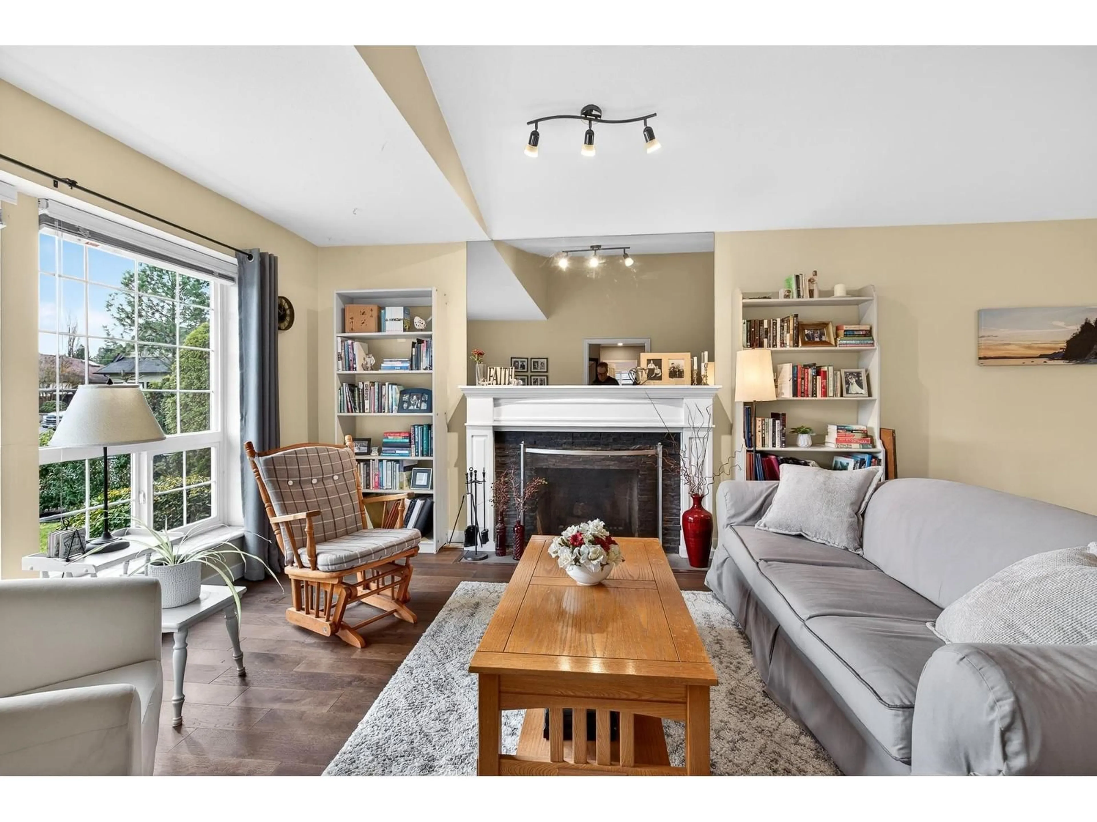 Living room with furniture, wood/laminate floor for 4851 208A STREET, Langley British Columbia V3A5X9