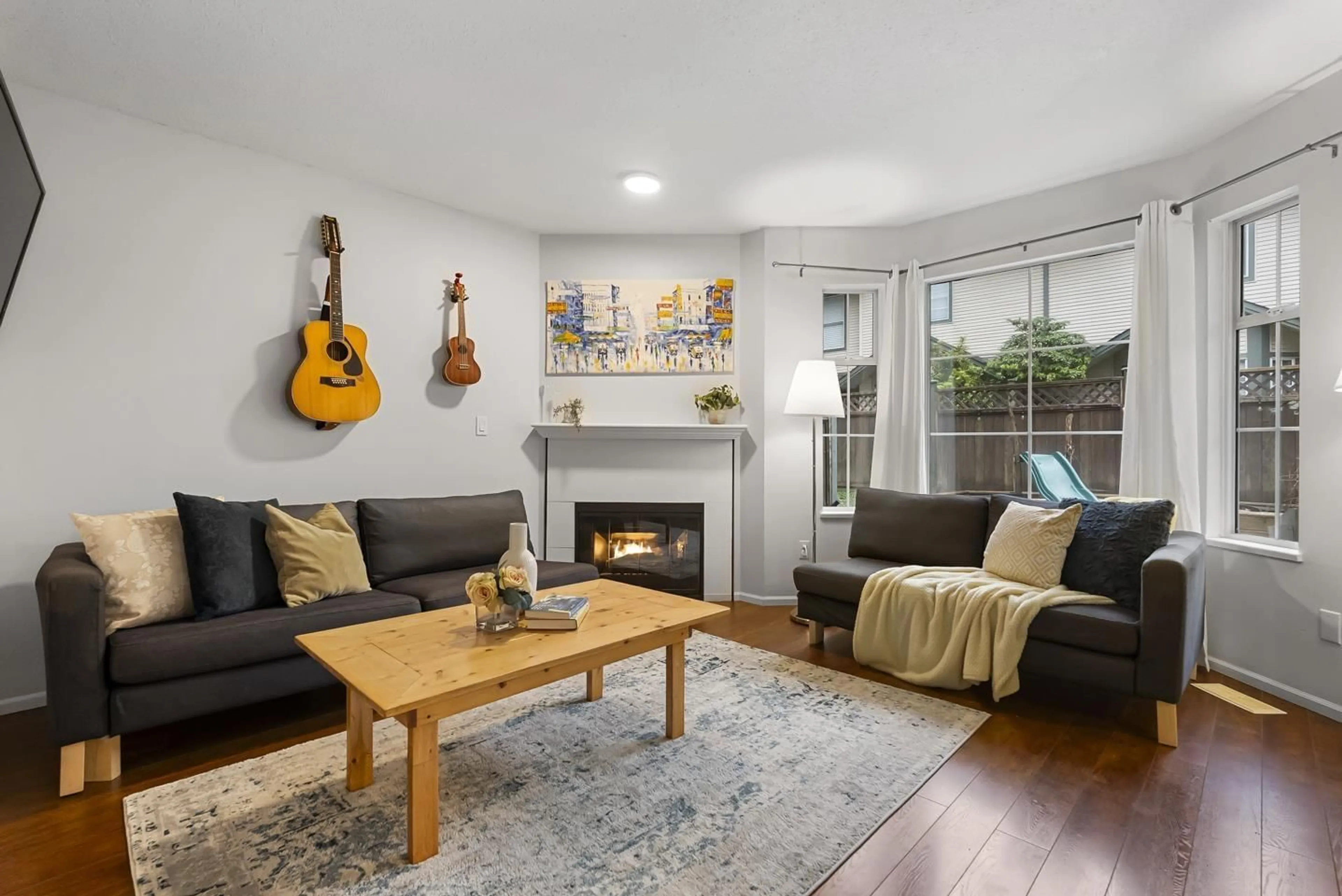 Living room with furniture, wood/laminate floor for 106 - 8655 KING GEORGE BOULEVARD, Surrey British Columbia V3W5C4