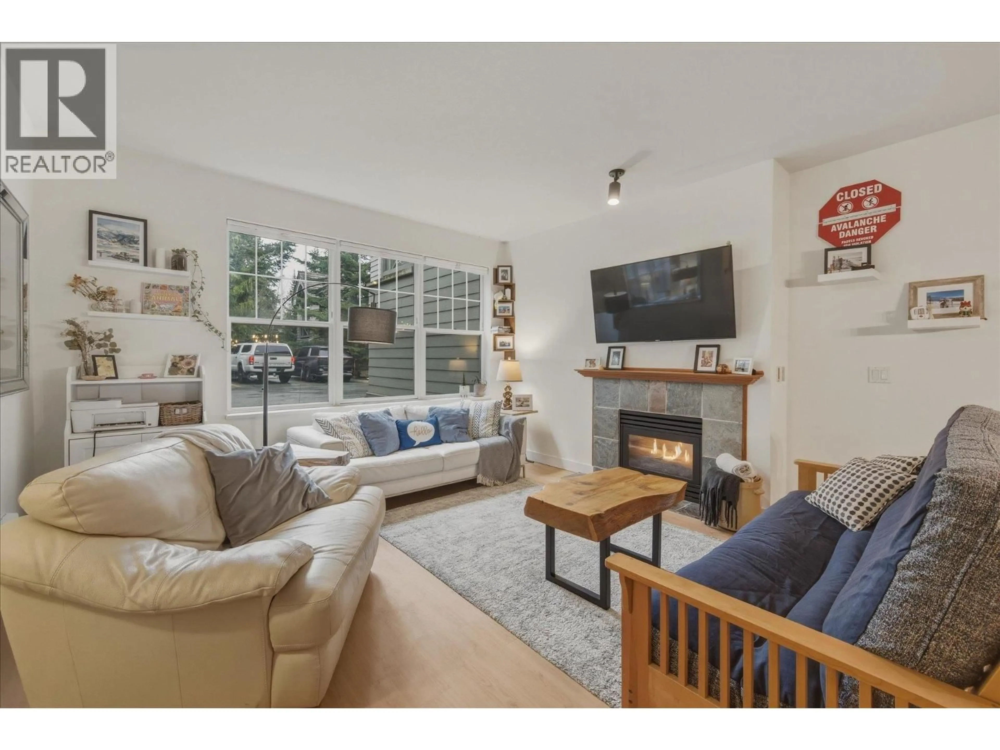 Living room with furniture, wood/laminate floor for 201 - 3300 PTARMIGAN PLACE, Whistler British Columbia V8E0V5