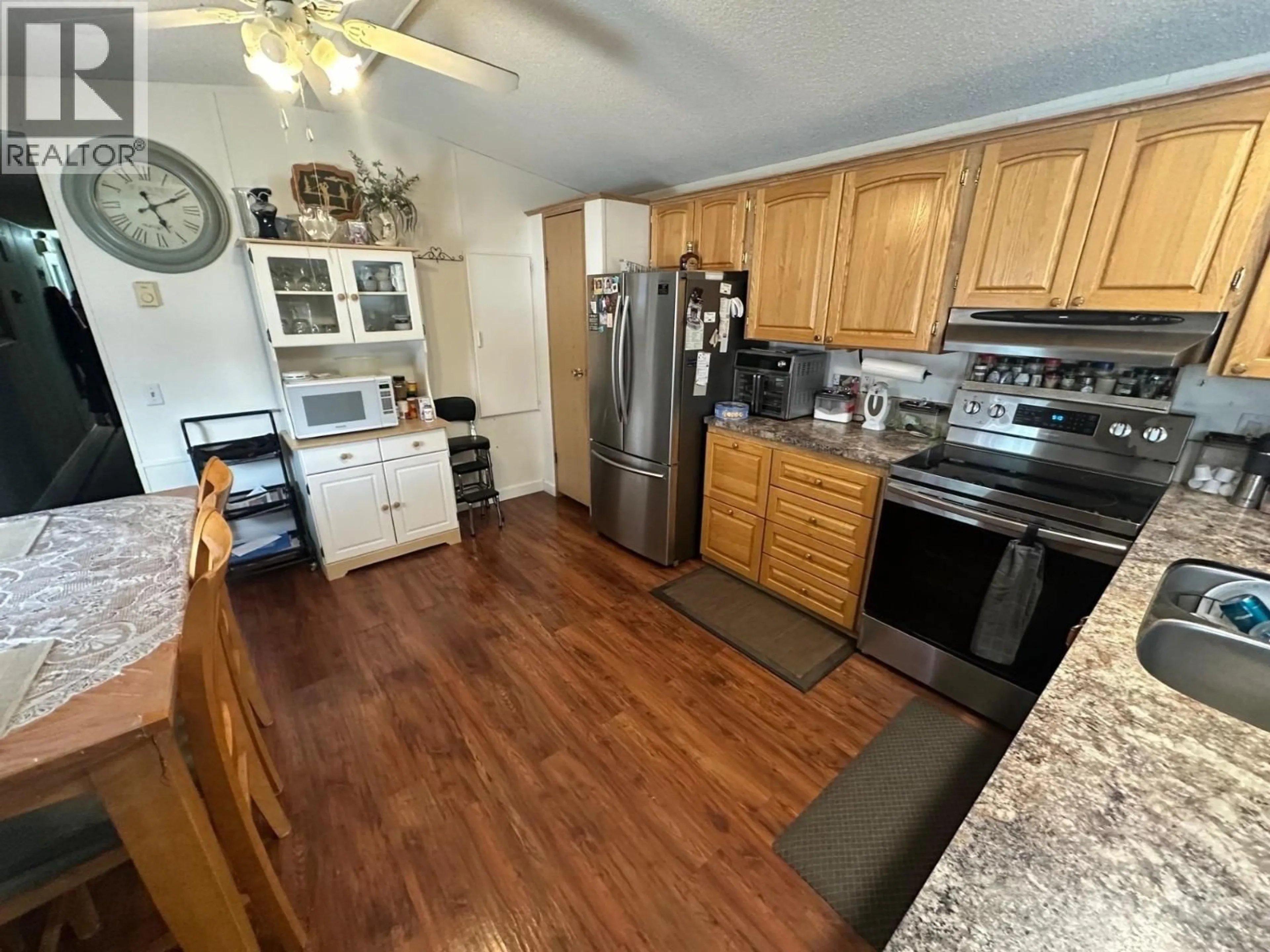 Open concept kitchen, wood/laminate floor for 10085 98 STREET, Taylor British Columbia V0C2K0