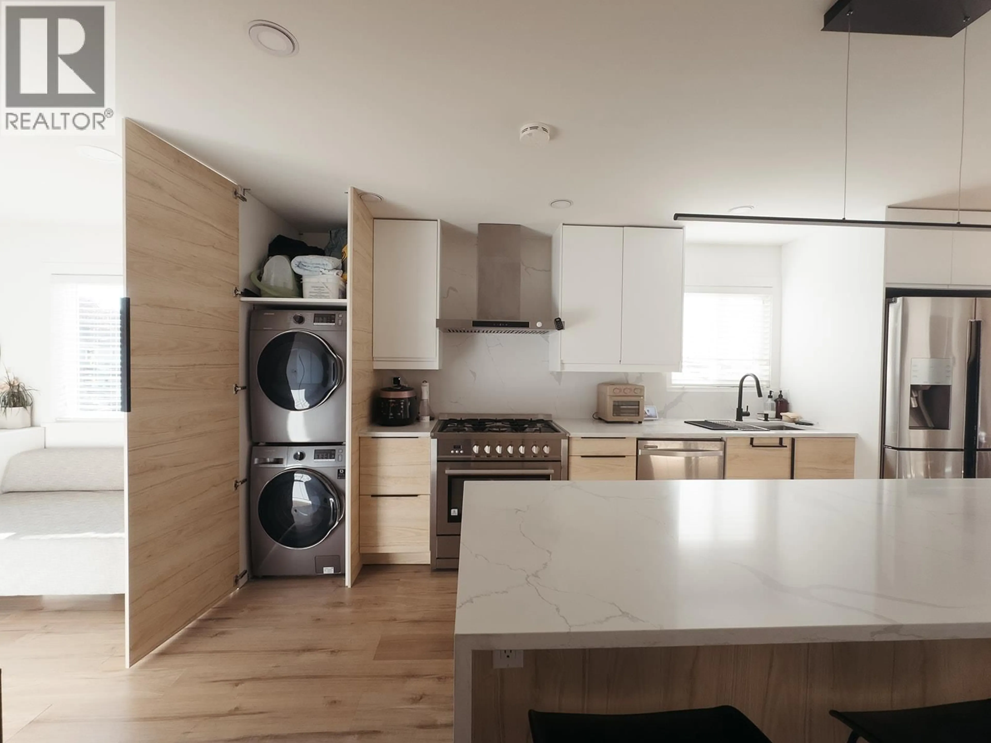 Kitchen with laundary machines, wood/laminate floor for 679 GAMMA AVENUE, Burnaby British Columbia V5C6A3