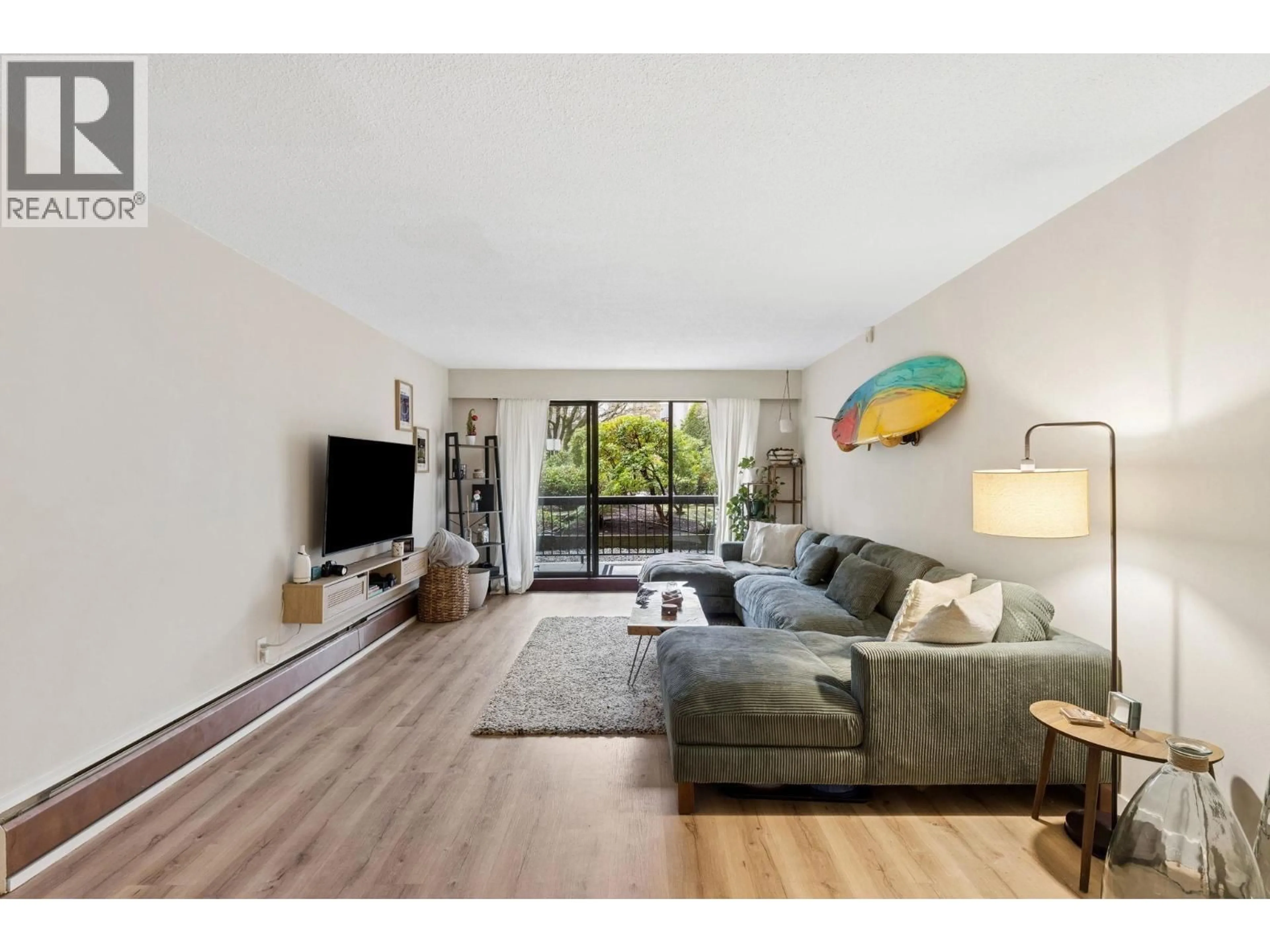 Living room with furniture, wood/laminate floor for 101 - 175 5TH STREET, North Vancouver British Columbia V7L1L3