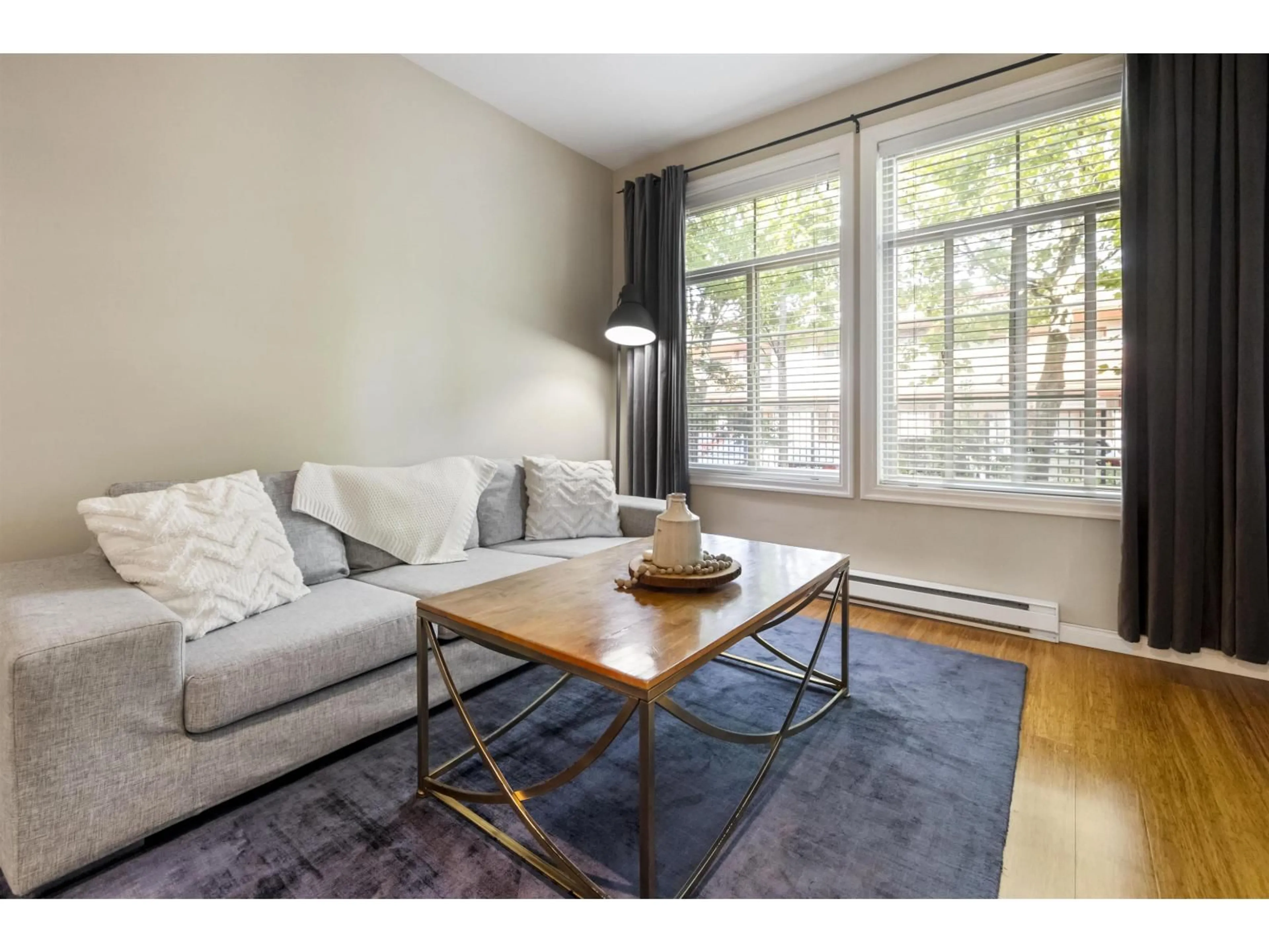 Living room with furniture, wood/laminate floor for 111 - 3355 ROSEMARY HEIGHTS DRIVE, Surrey British Columbia V3Z2H5