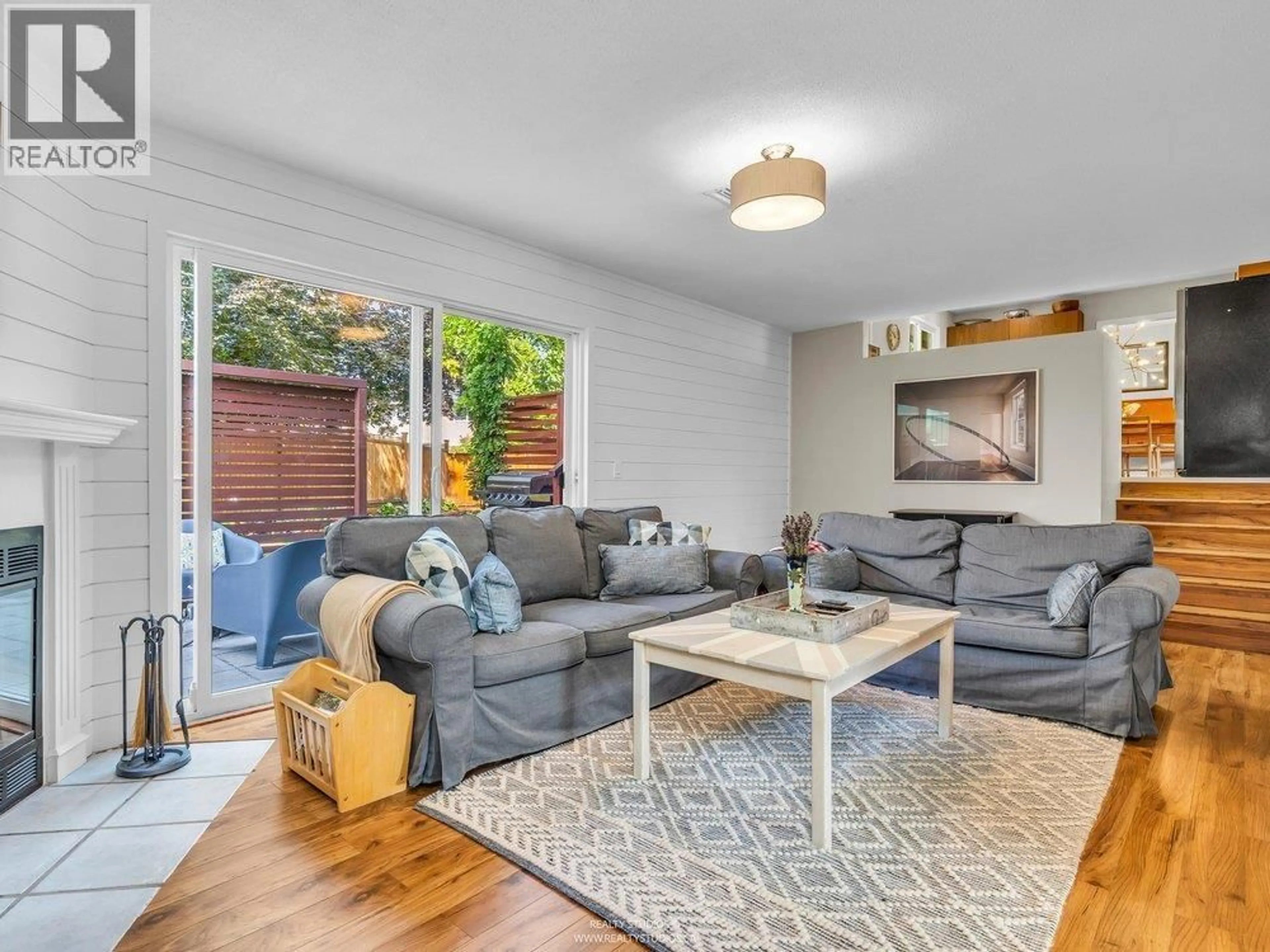 Living room with furniture, wood/laminate floor for 999 53A STREET, Delta British Columbia V4M3E2