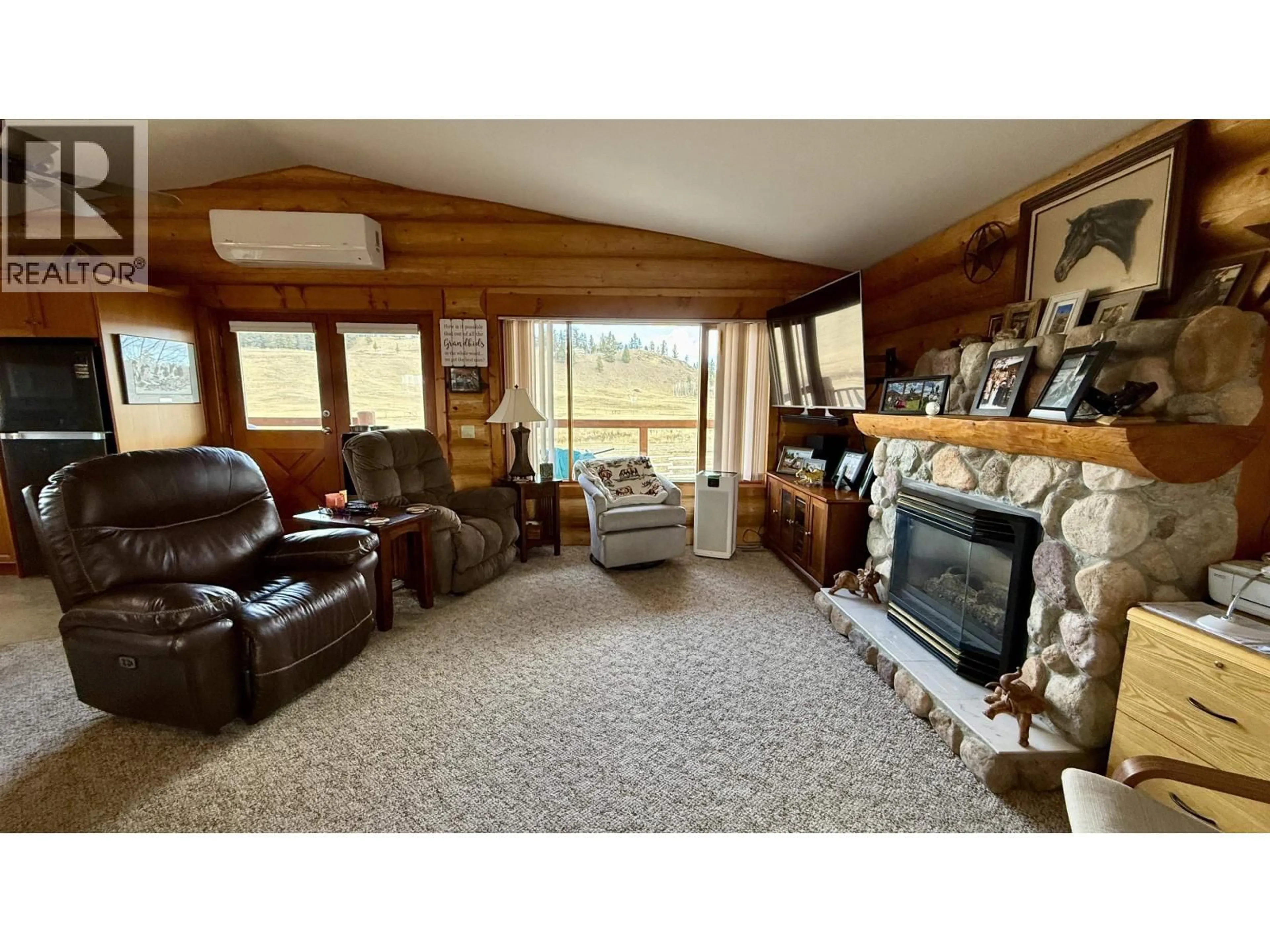 Living room with furniture, wood/laminate floor for 5393 TATTON STATION ROAD, 100 Mile House British Columbia V0K2E1