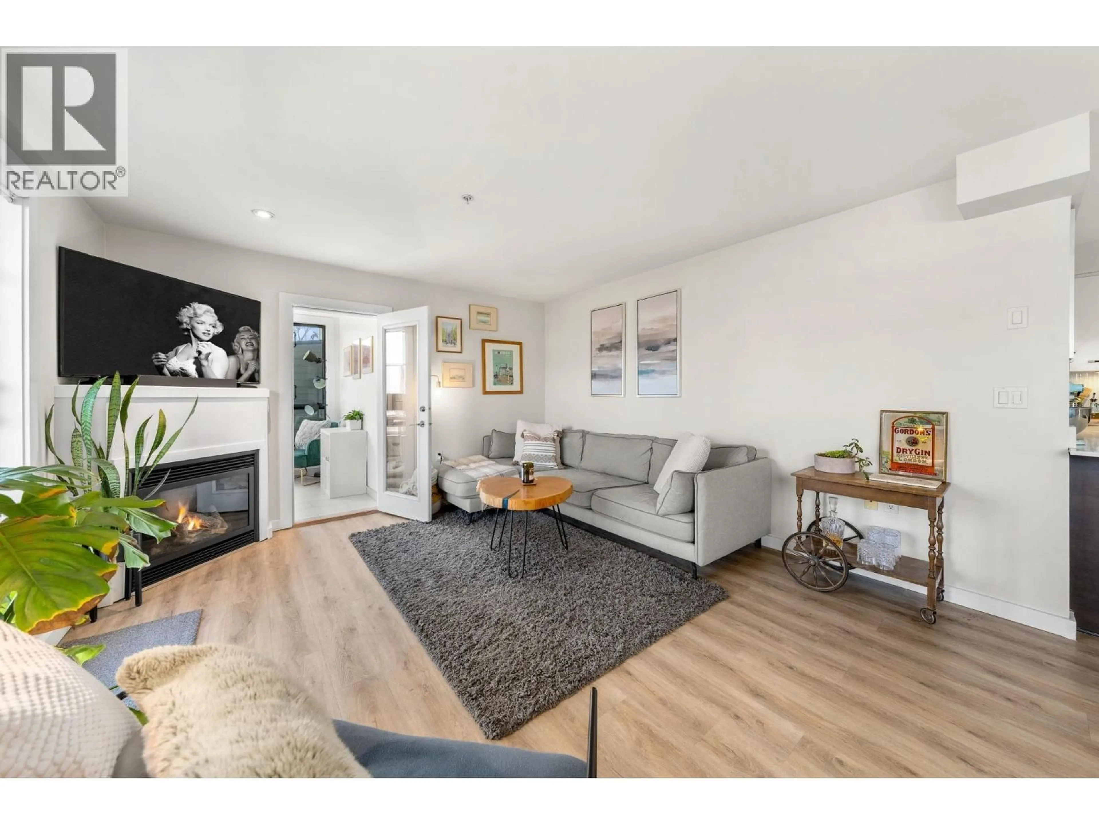 Living room with furniture, wood/laminate floor for 206 - 935 16TH STREET, North Vancouver British Columbia V7P1R2