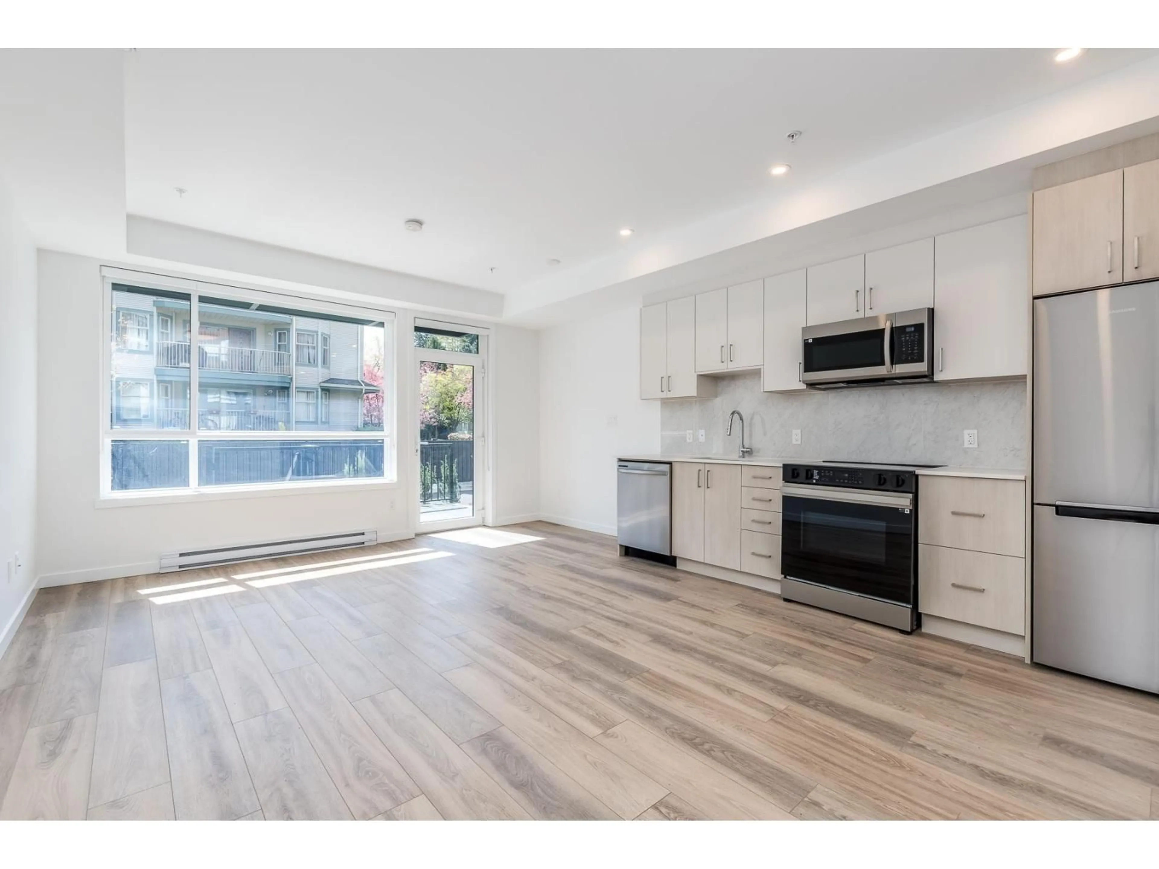 Open concept kitchen, wood/laminate floor for E103 - 13858 108 AVENUE, Surrey British Columbia V3T0T8