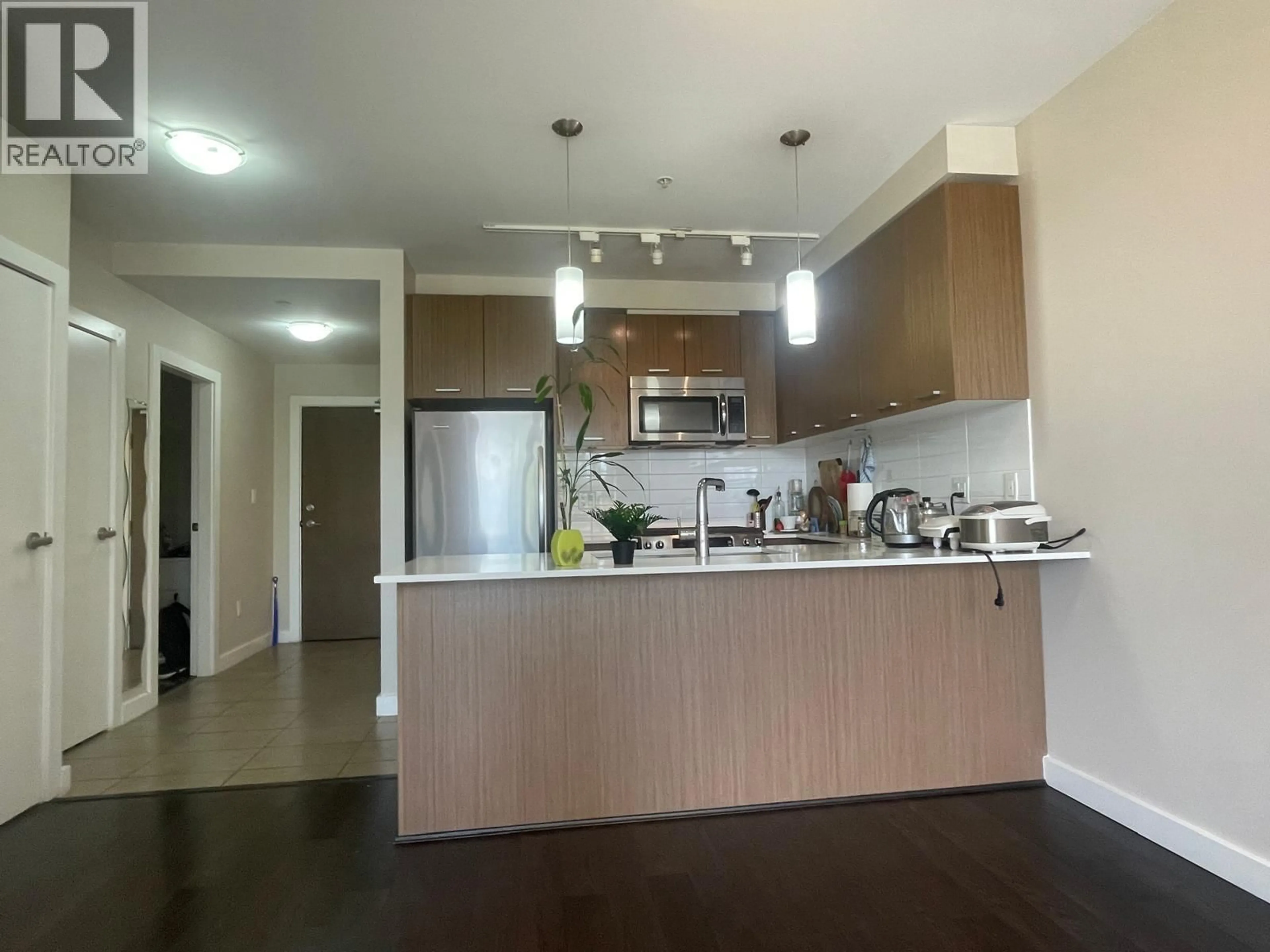 Open concept kitchen, wood/laminate floor for 209 - 1182 16TH STREET, North Vancouver British Columbia V7P0B3