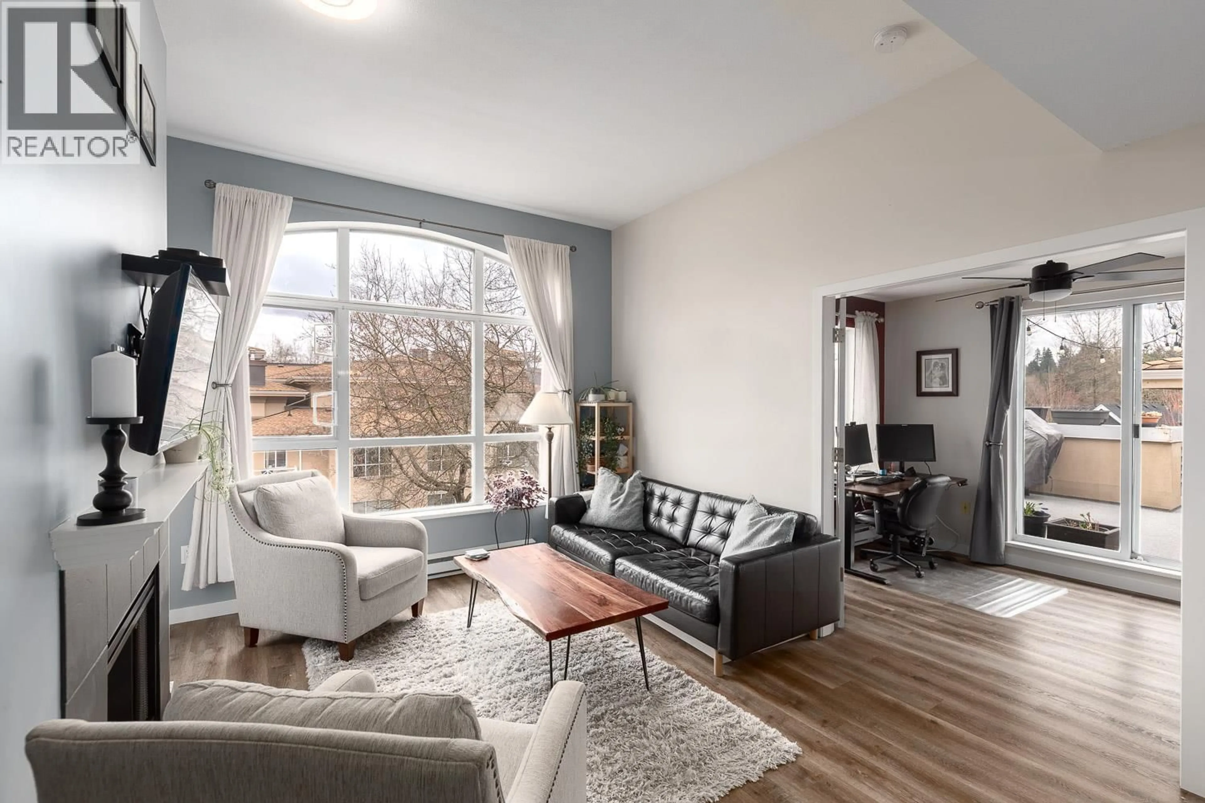Living room with furniture, wood/laminate floor for 402 - 2559 PARKVIEW LANE, Port Coquitlam British Columbia V3C6M1