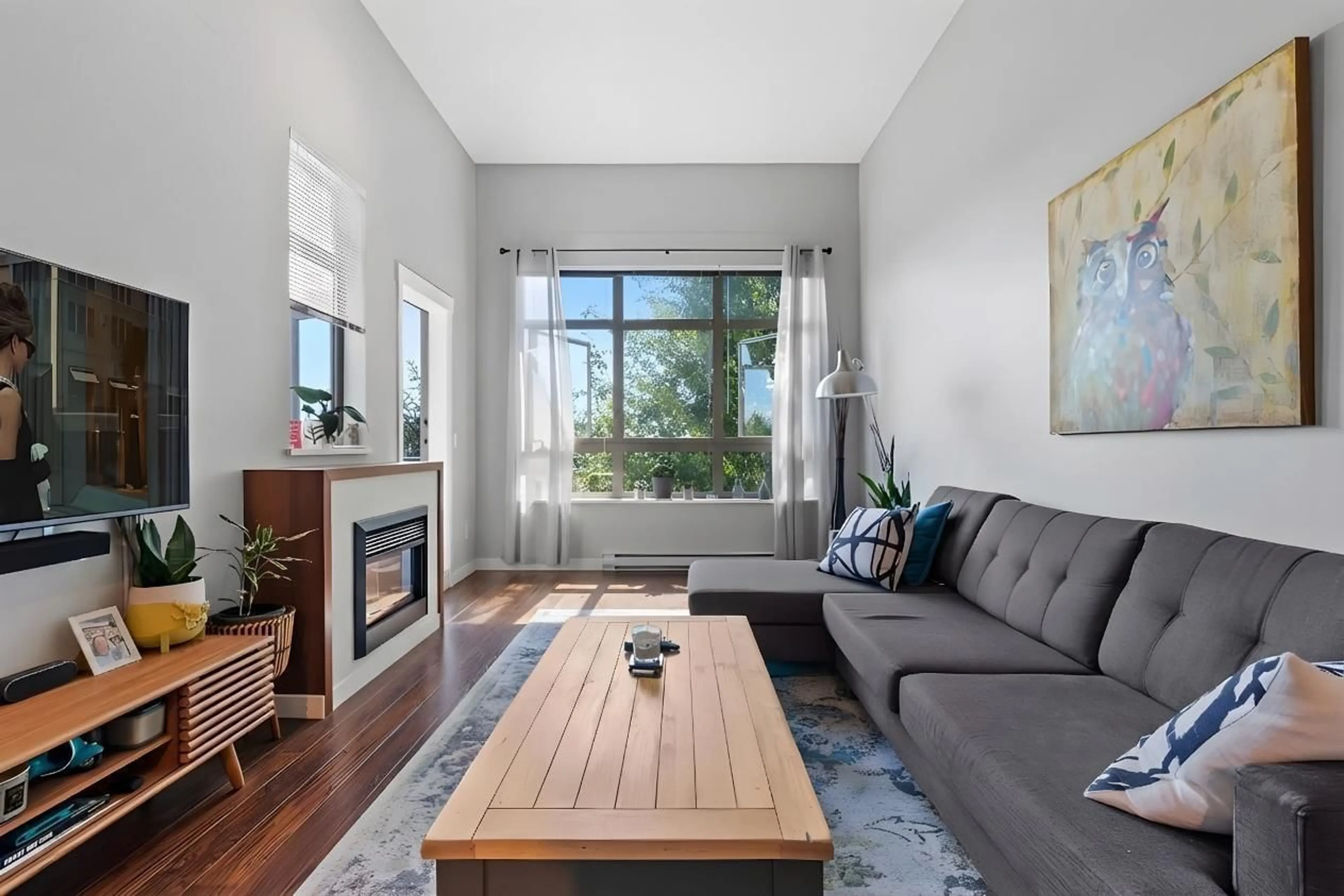 Living room with furniture, wood/laminate floor for 421 - 15918 26 AVENUE, Surrey British Columbia V3Z5K3