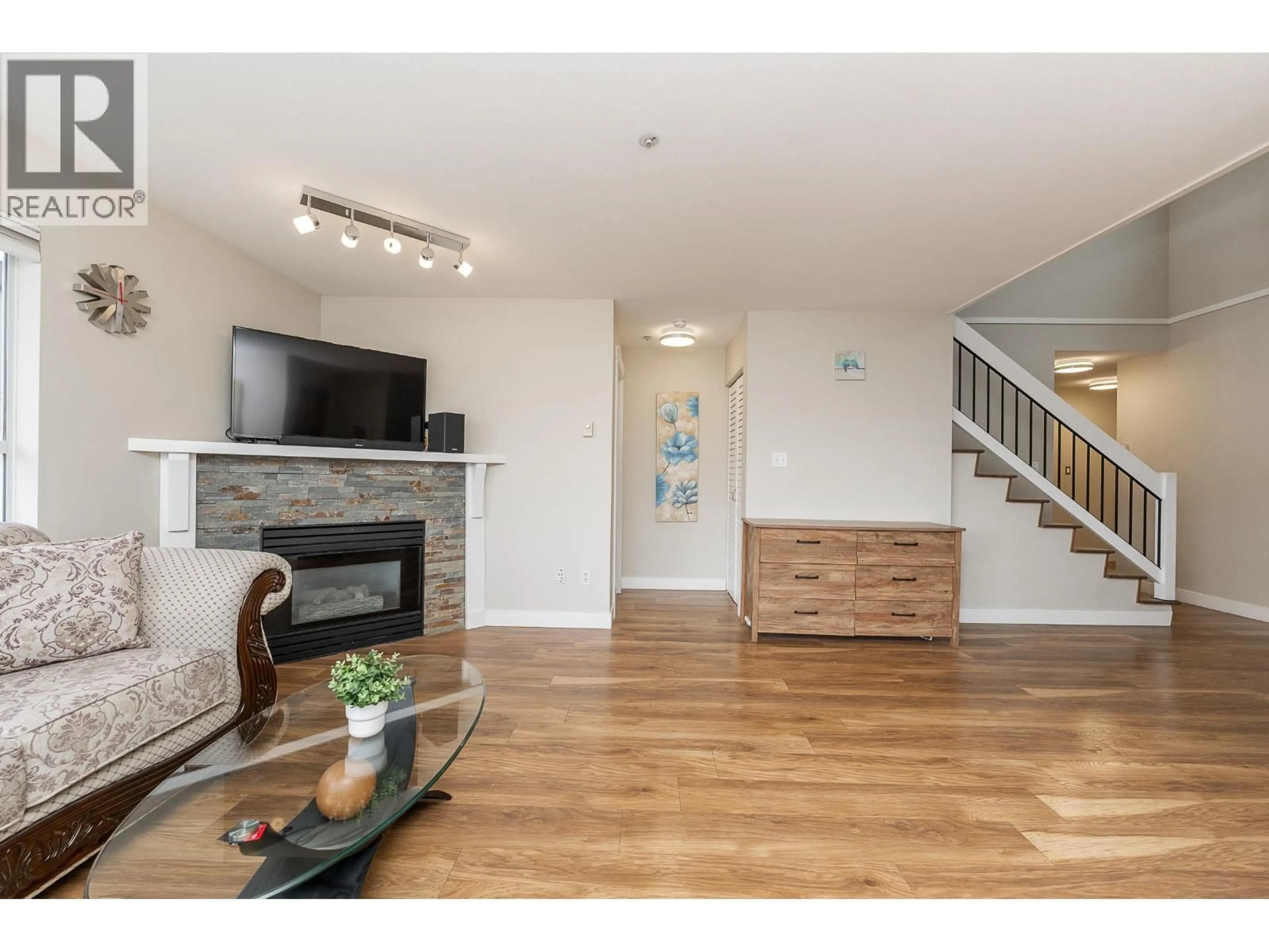 Living room with furniture, wood/laminate floor for 406 - 2285 PITT RIVER ROAD, Port Coquitlam British Columbia V3C1R7