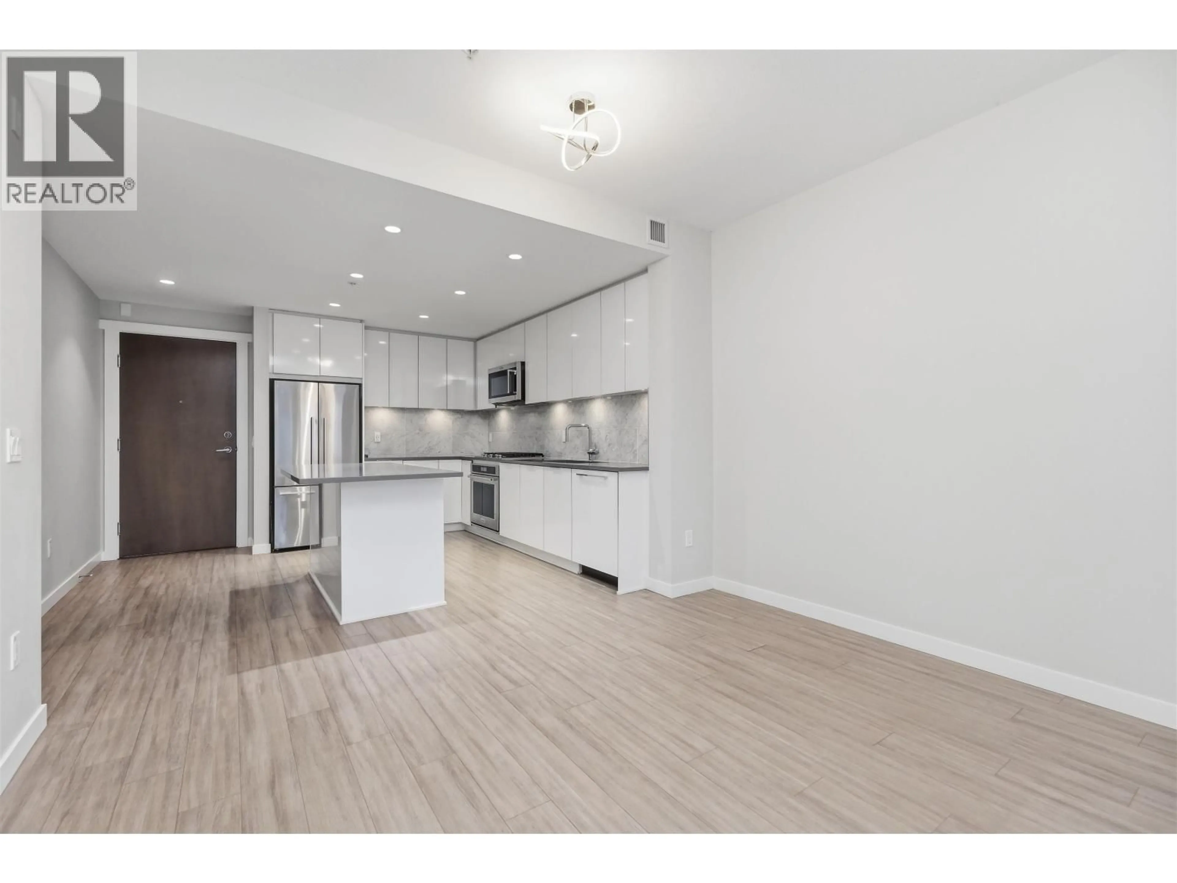 Open concept kitchen, wood/laminate floor for 121 - 2651 LIBRARY LANE, North Vancouver British Columbia V7J0C1