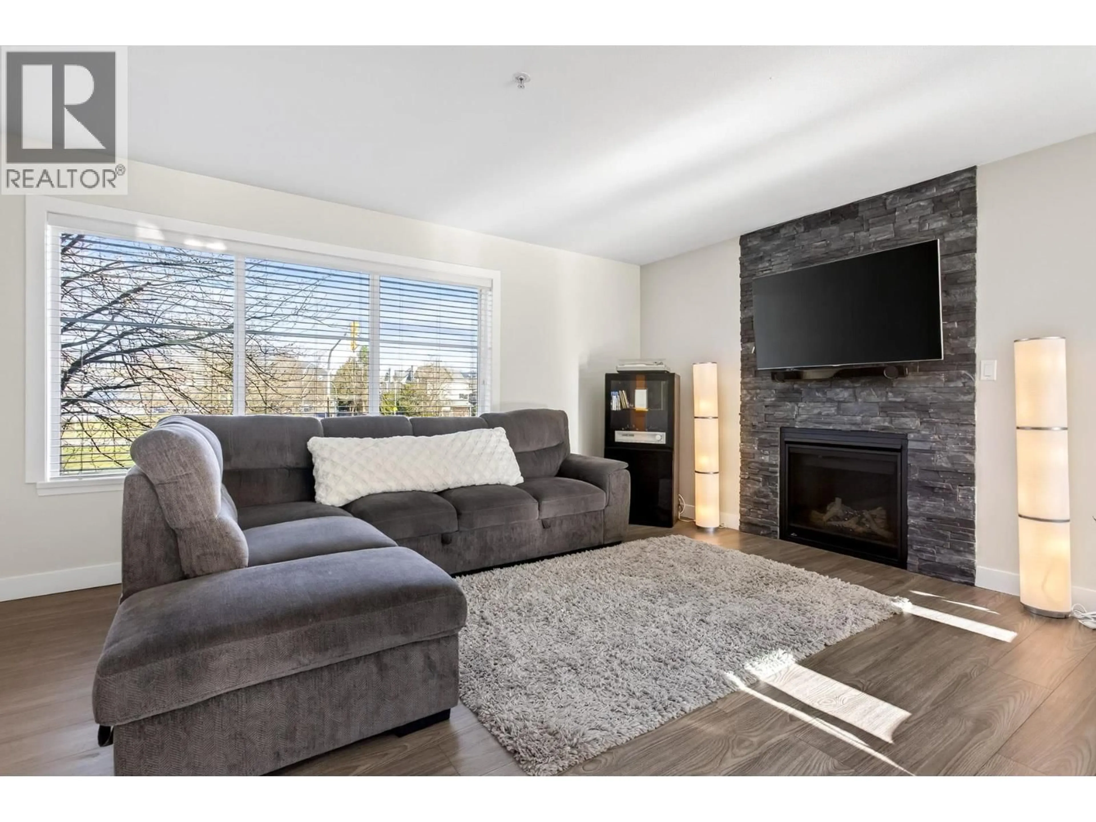 Living room with furniture, wood/laminate floor for 20 - 2488 PITT RIVER ROAD, Port Coquitlam British Columbia V3C1R9