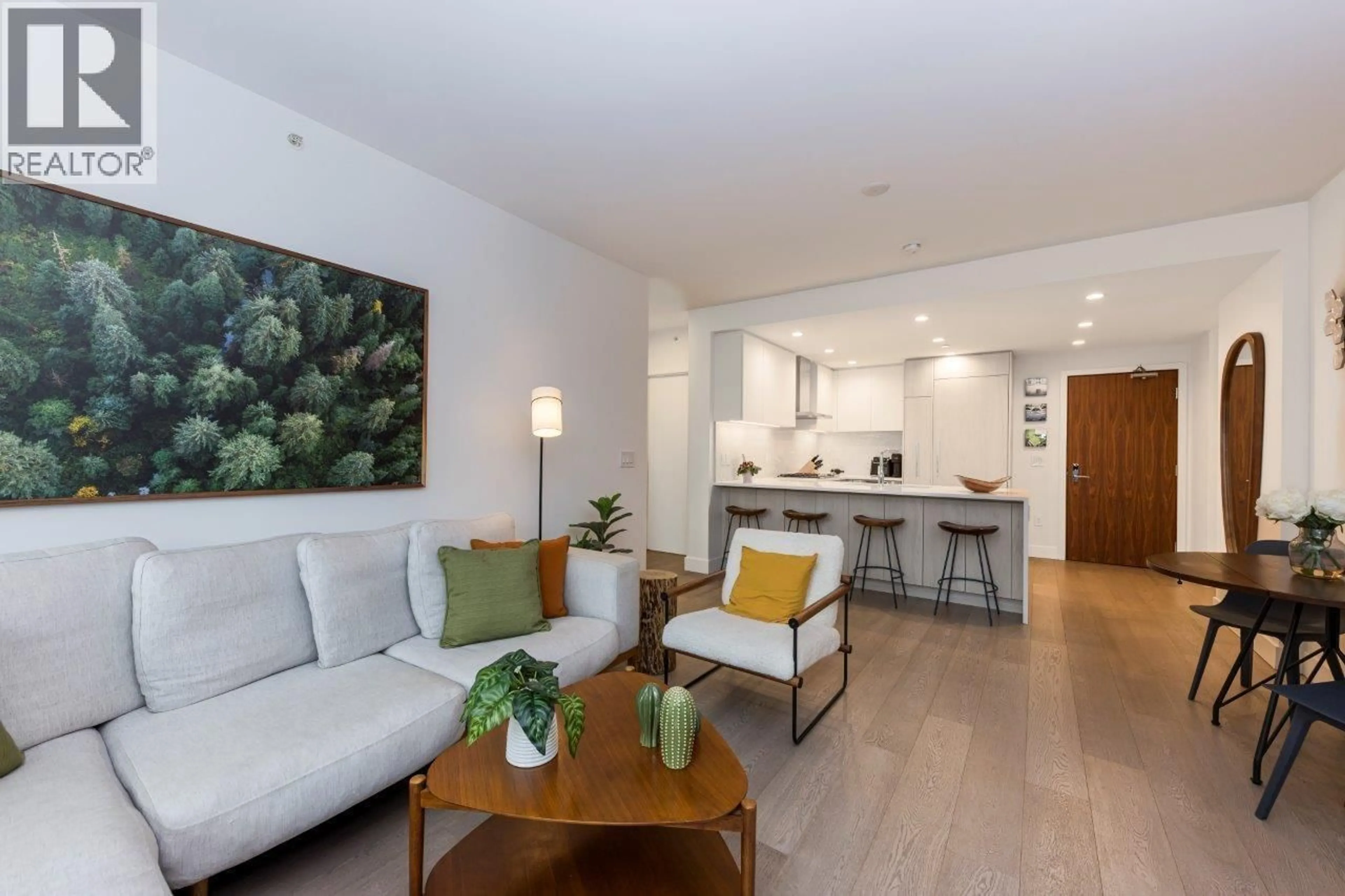 Living room with furniture, wood/laminate floor for 206 - 177 3RD STREET, North Vancouver British Columbia V7M0G5