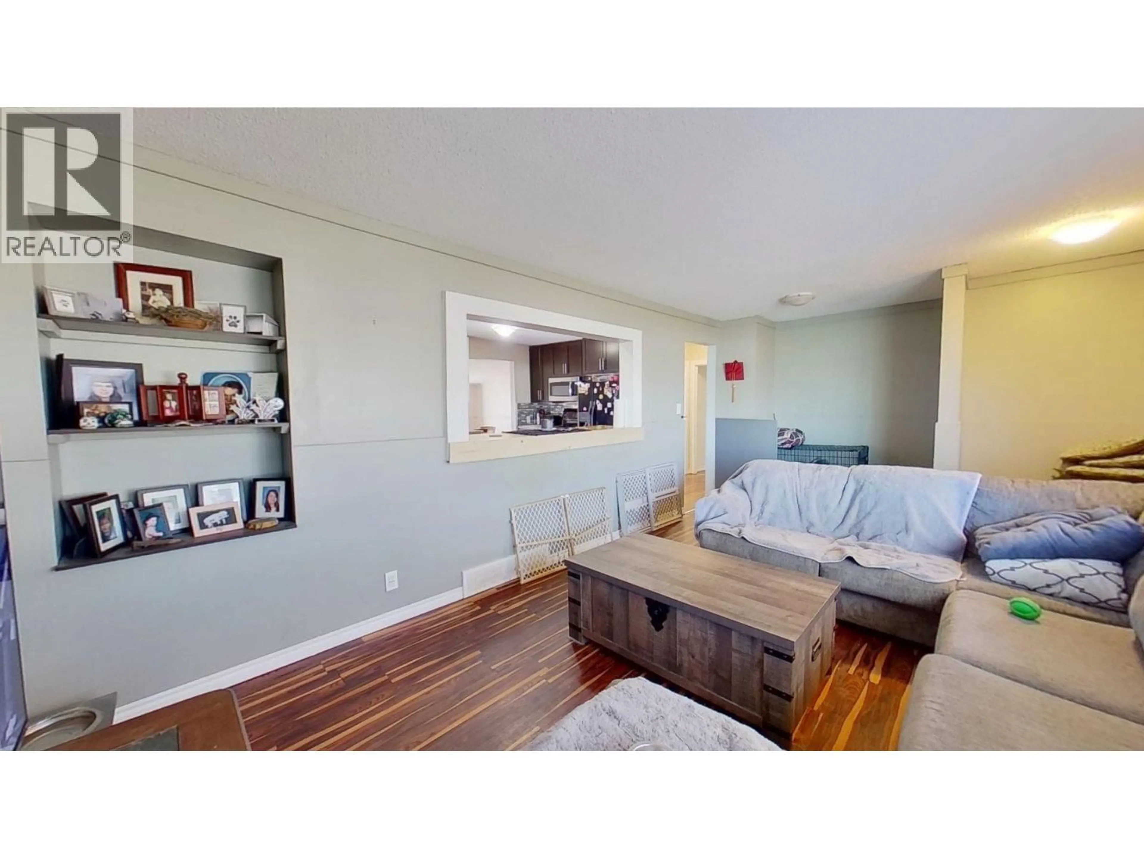 Living room with furniture, wood/laminate floor for 8315 94 AVENUE, Fort St. John British Columbia V1J1E7