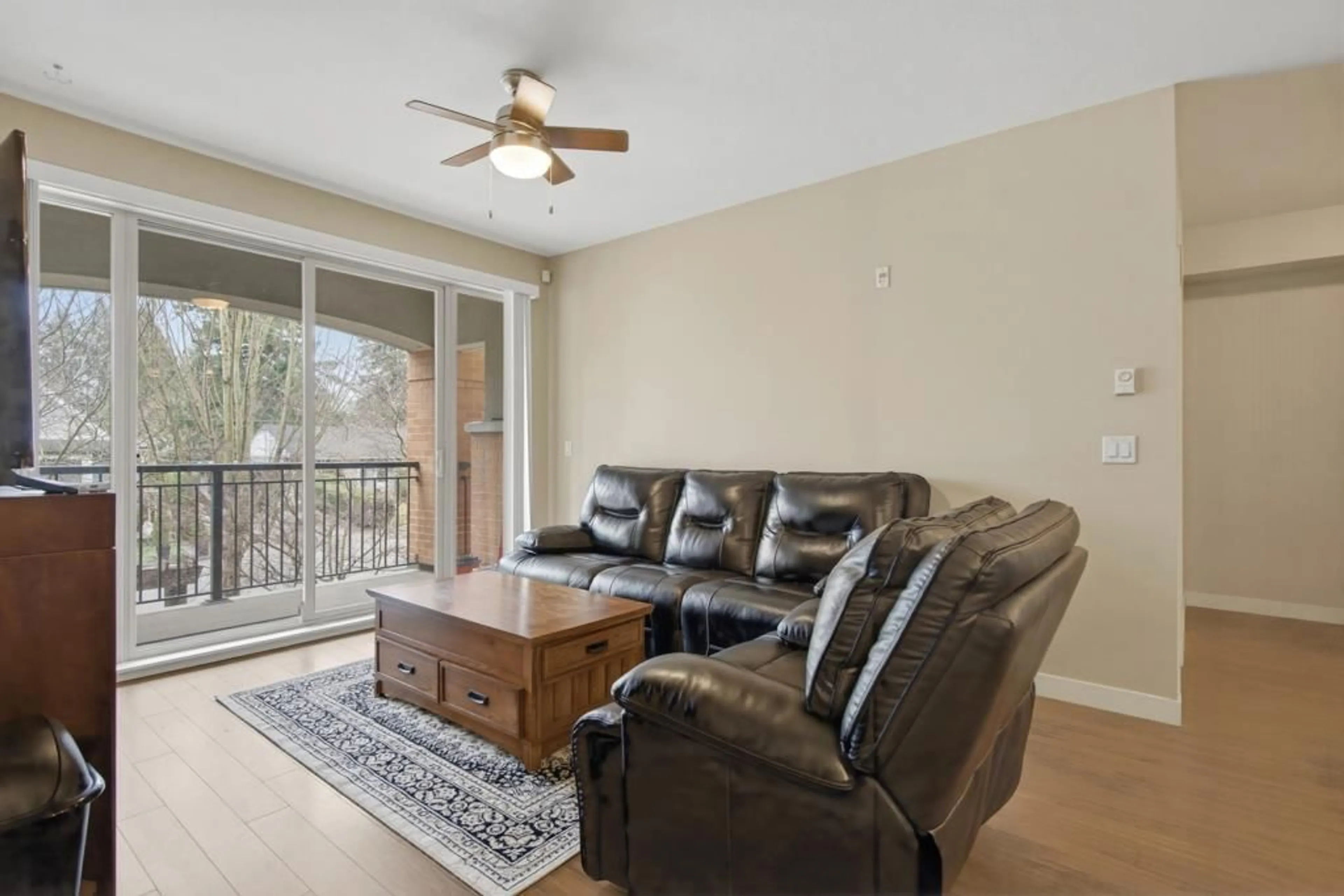 Living room with furniture, wood/laminate floor for 209 - 33545 RAINBOW AVENUE, Abbotsford British Columbia V2S0B9