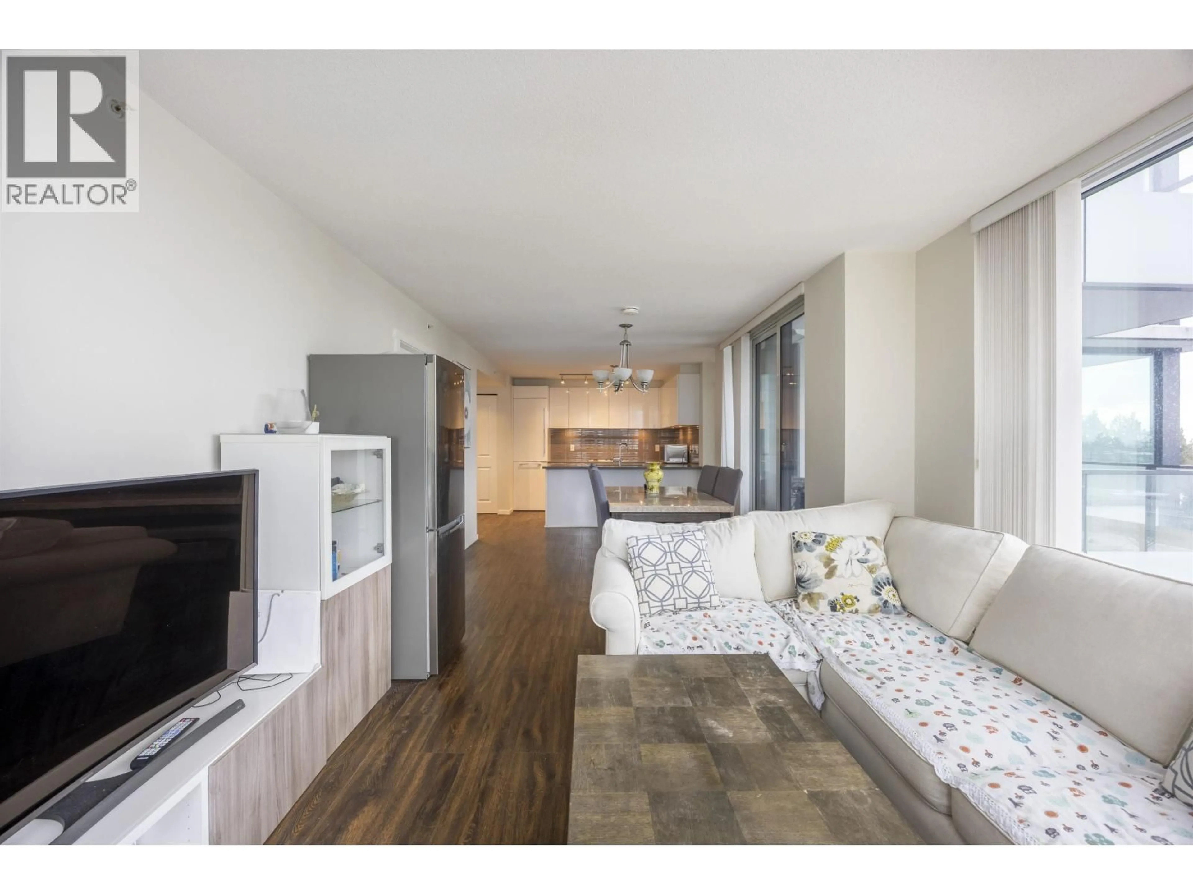 Living room with furniture, wood/laminate floor for 705 - 6658 DOW AVENUE, Burnaby British Columbia V5H0C7