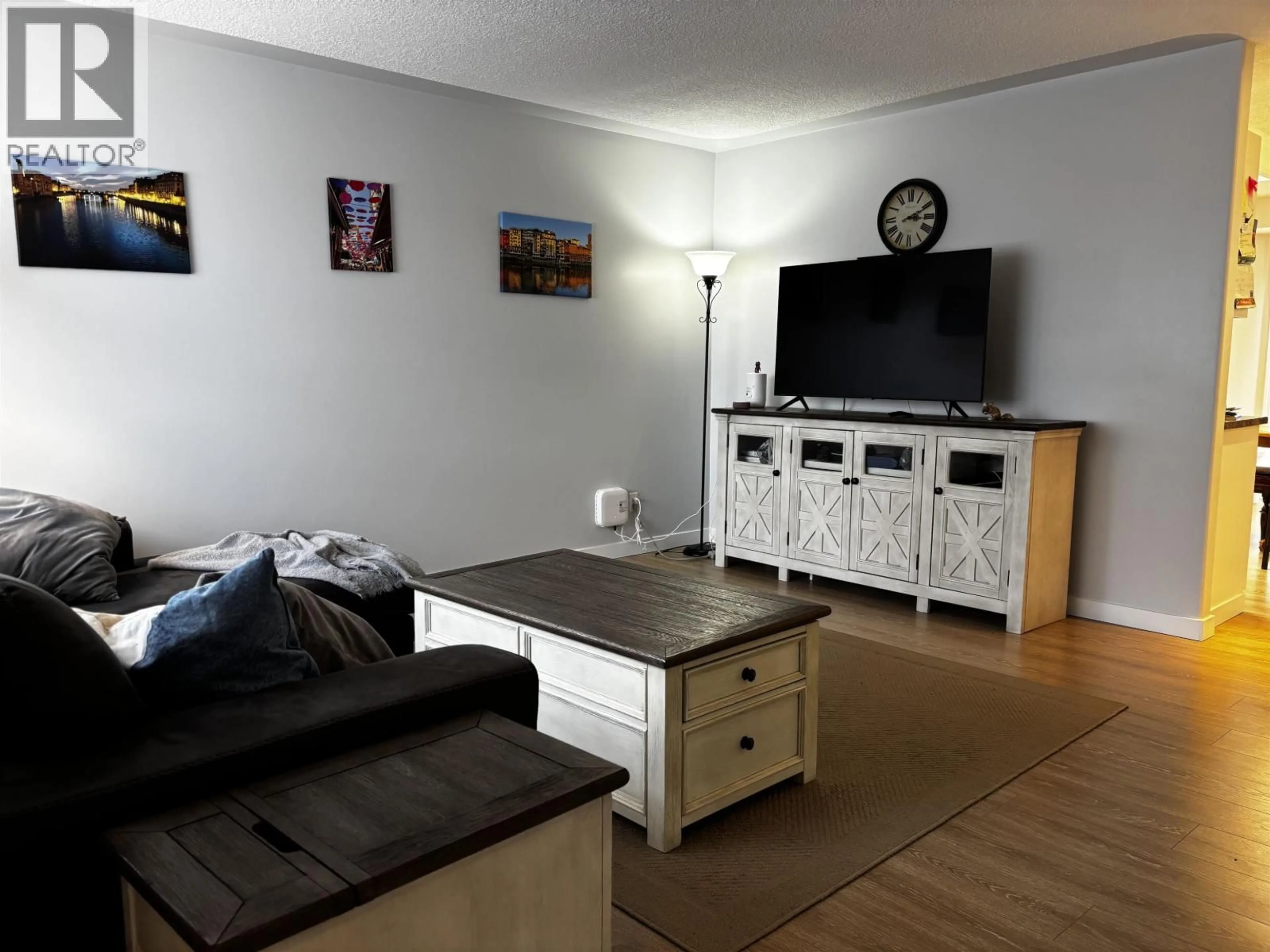 Living room with furniture, wood/laminate floor for 9011 99 AVENUE, Fort St. John British Columbia V1J5S2