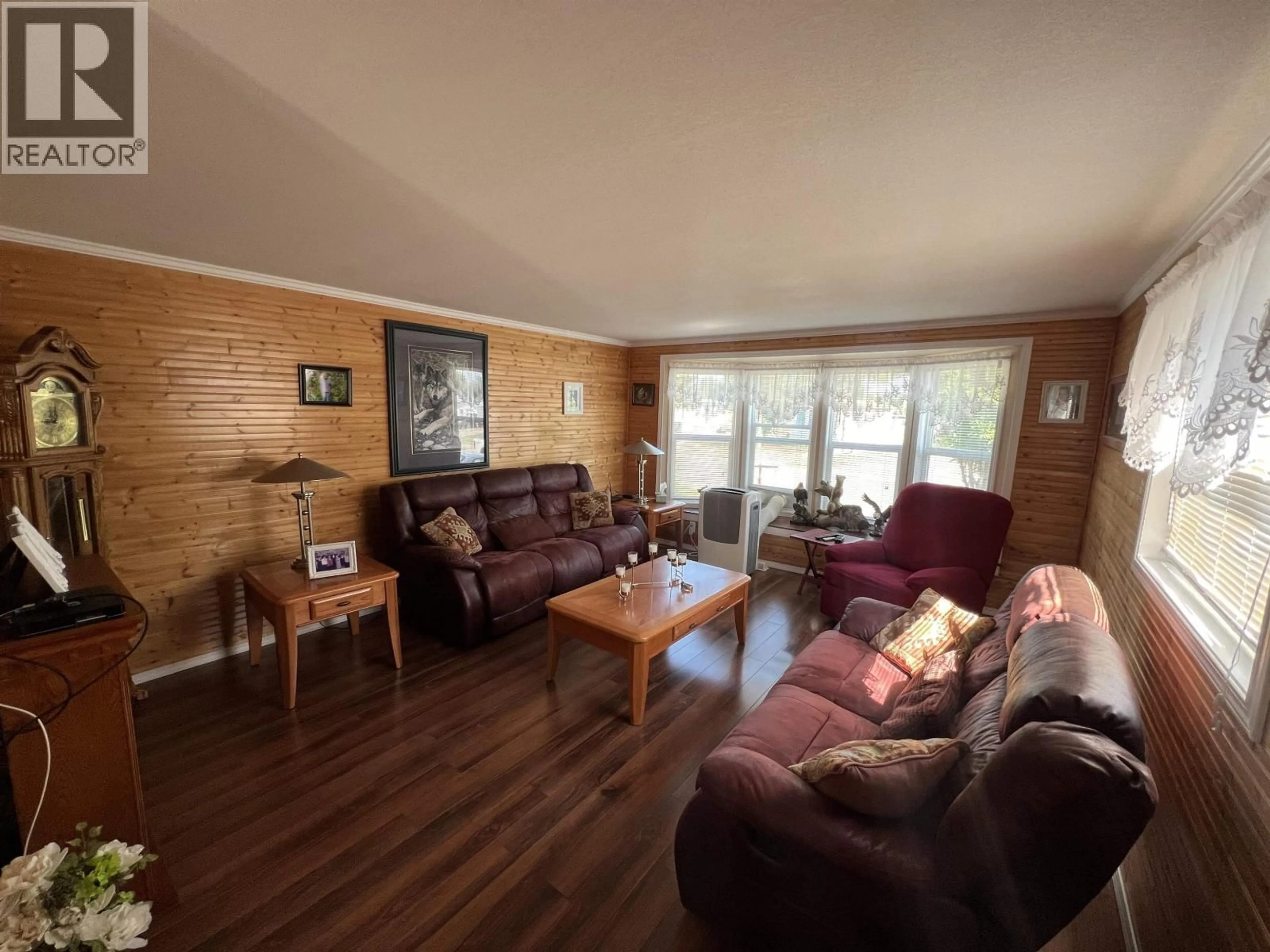 Living room with furniture, wood/laminate floor for 5223 41 STREET, Fort Nelson British Columbia V0C1R0