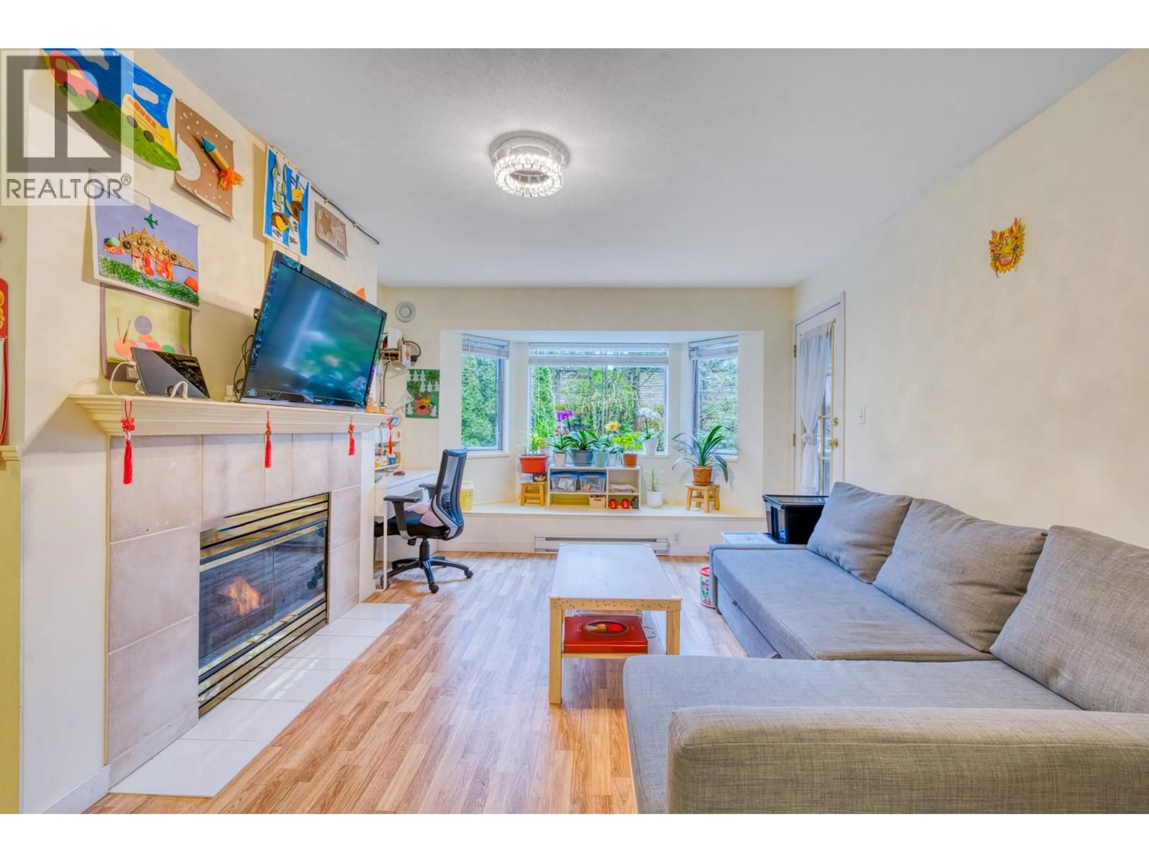 Living room with furniture, wood/laminate floor for 207 - 3738 NORFOLK STREET, Burnaby British Columbia V5G4V4