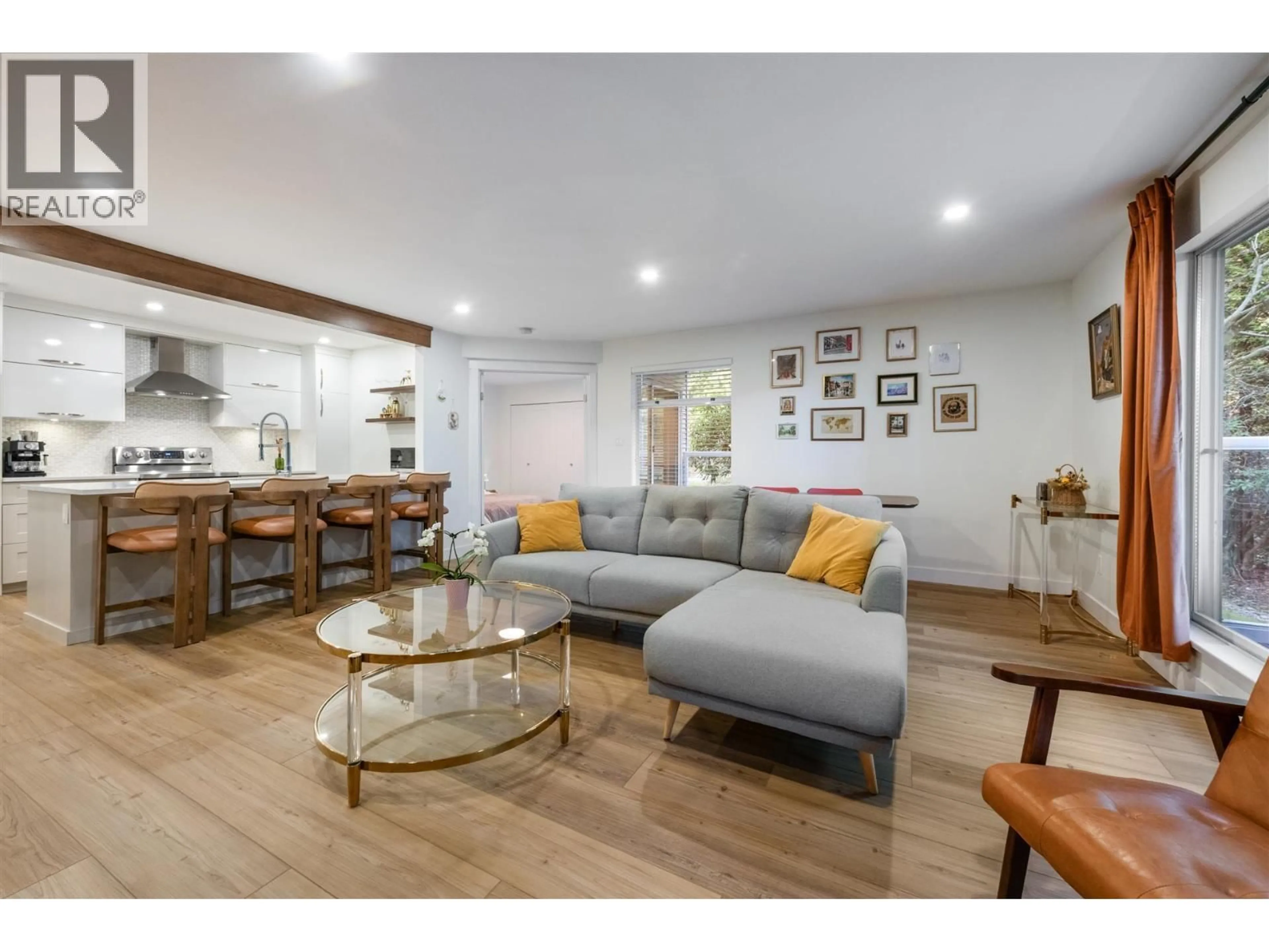 Living room with furniture, wood/laminate floor for 208 - 2733 ATLIN PLACE, Coquitlam British Columbia V3C5B1