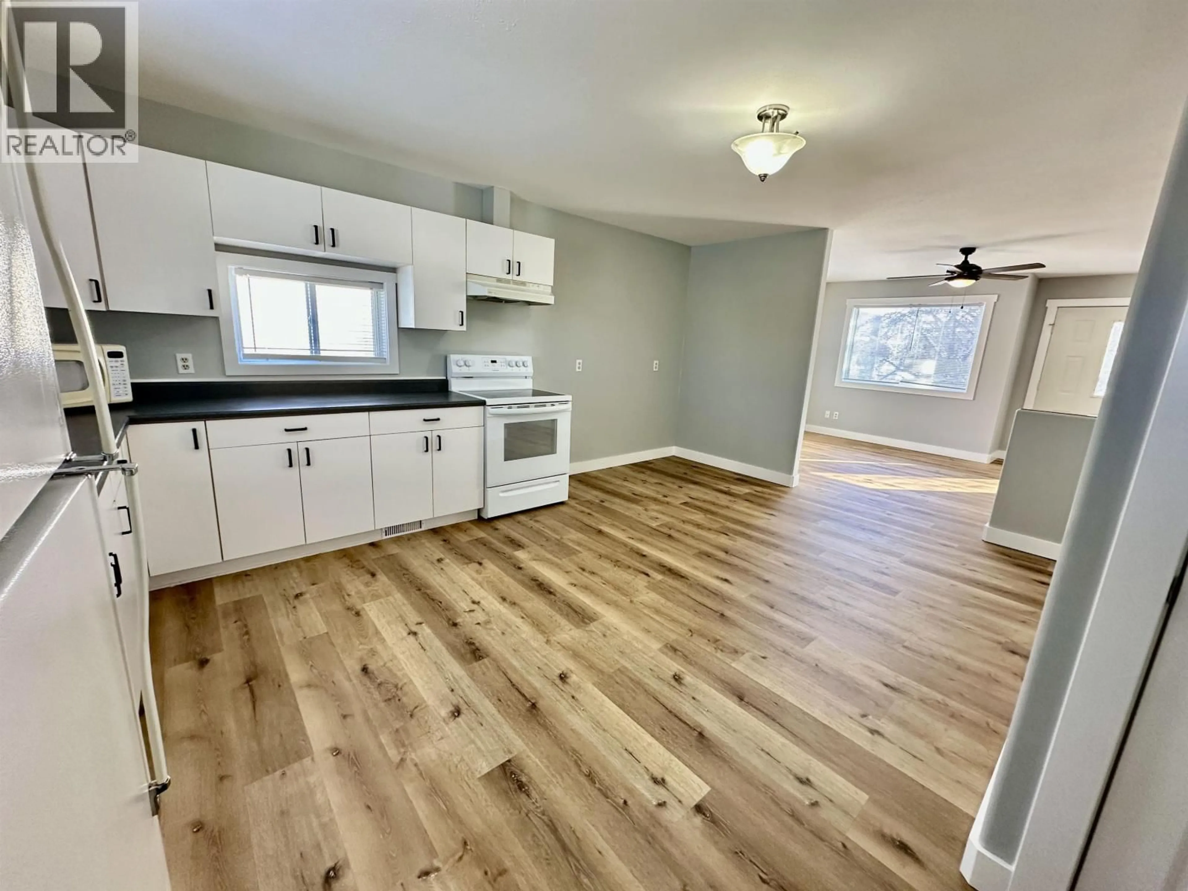 Open concept kitchen, wood/laminate floor for 10316 96 AVENUE, Fort St. John British Columbia V1J1L4