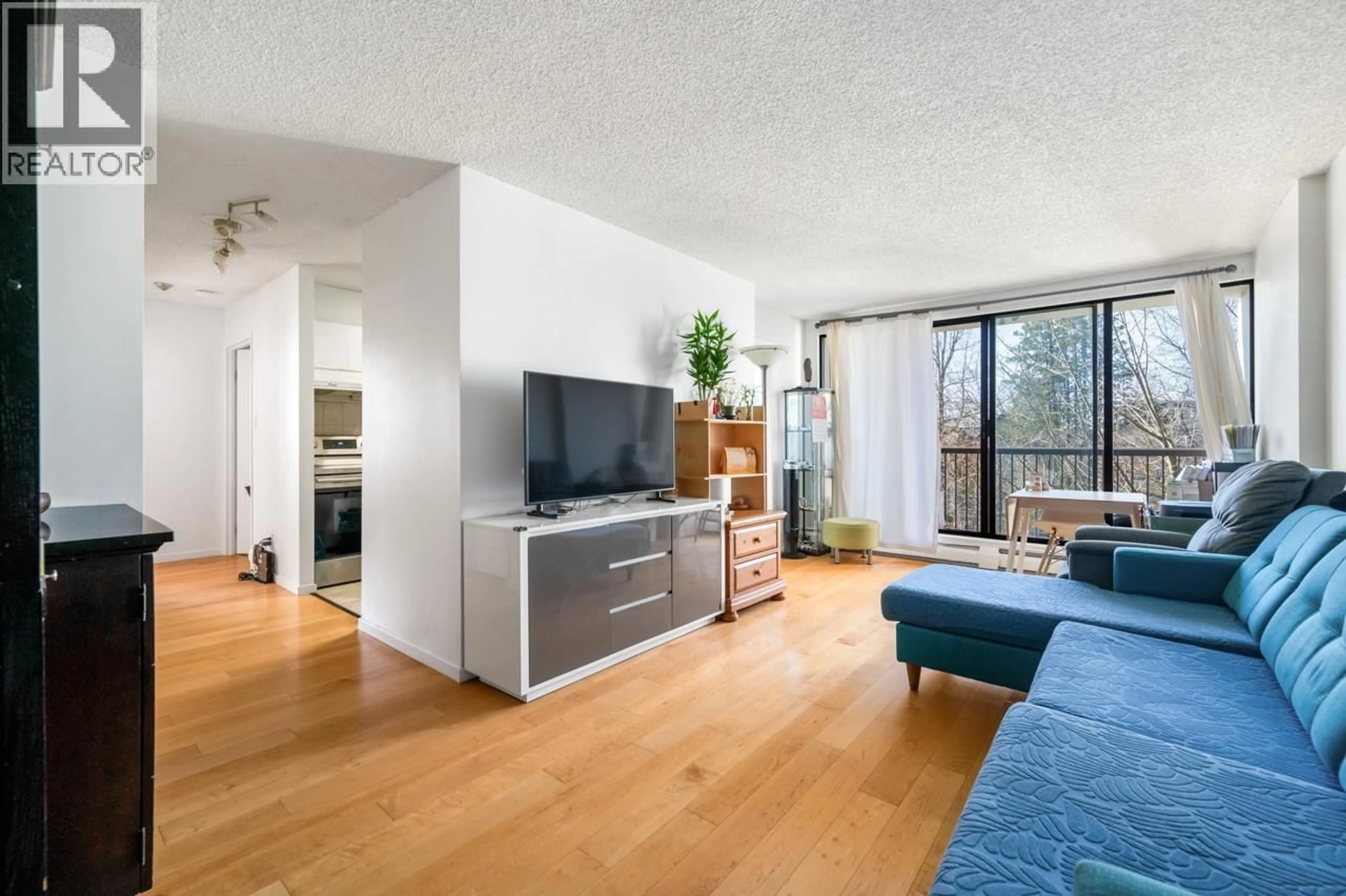 Living room with furniture, wood/laminate floor for 304 - 7100 GILBERT ROAD, Richmond British Columbia V7C5C3
