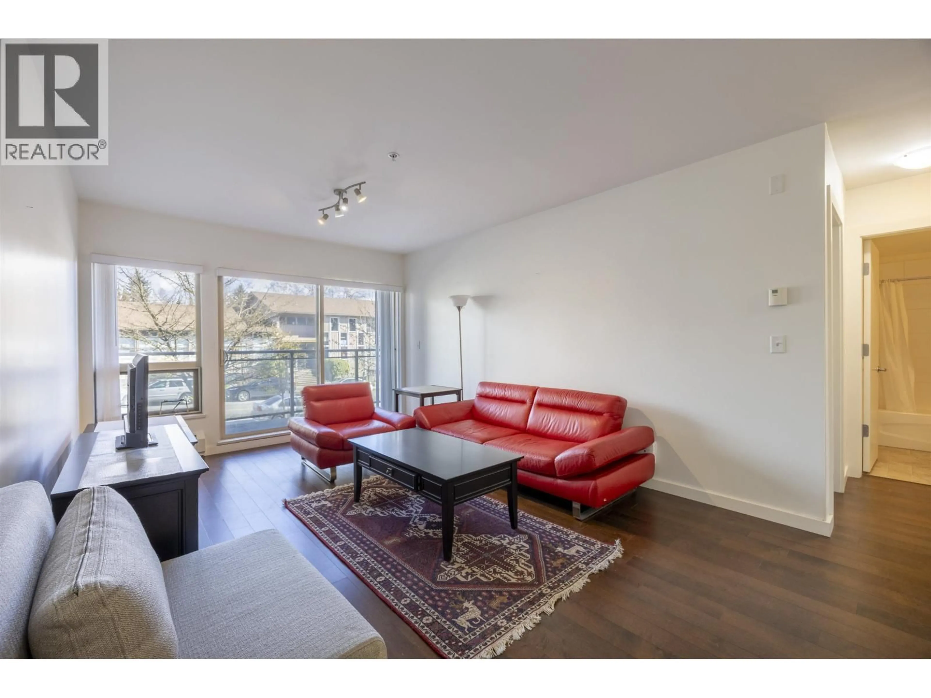 Living room with furniture, wood/laminate floor for 206 - 1033 ST. GEORGES AVENUE, North Vancouver British Columbia V7L3H5