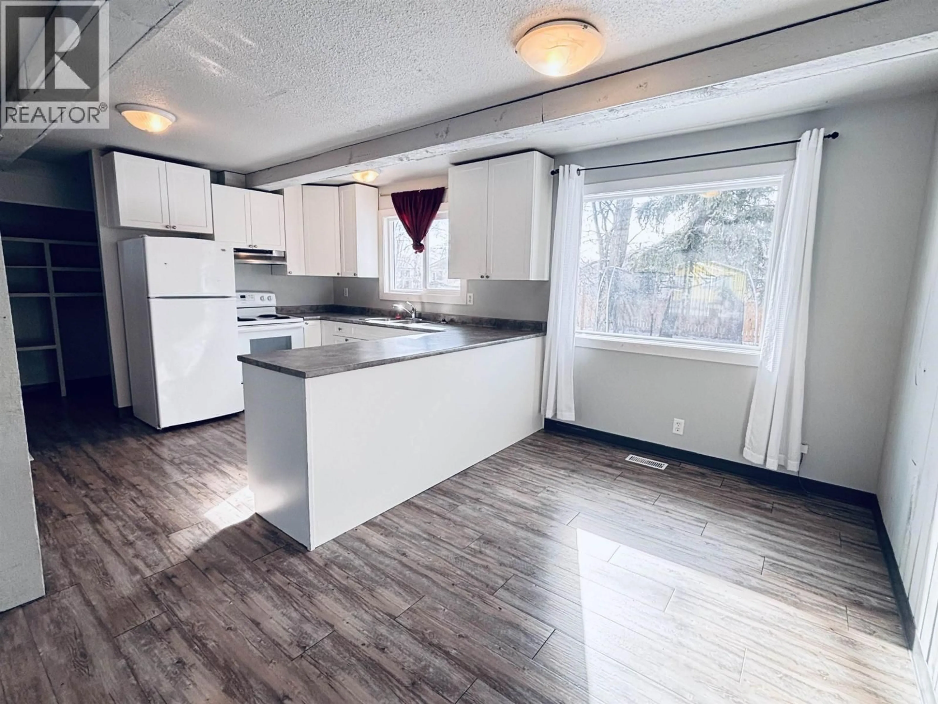 Open concept kitchen, wood/laminate floor for 2981 MELODY CRESCENT, Prince George British Columbia V2N2T8