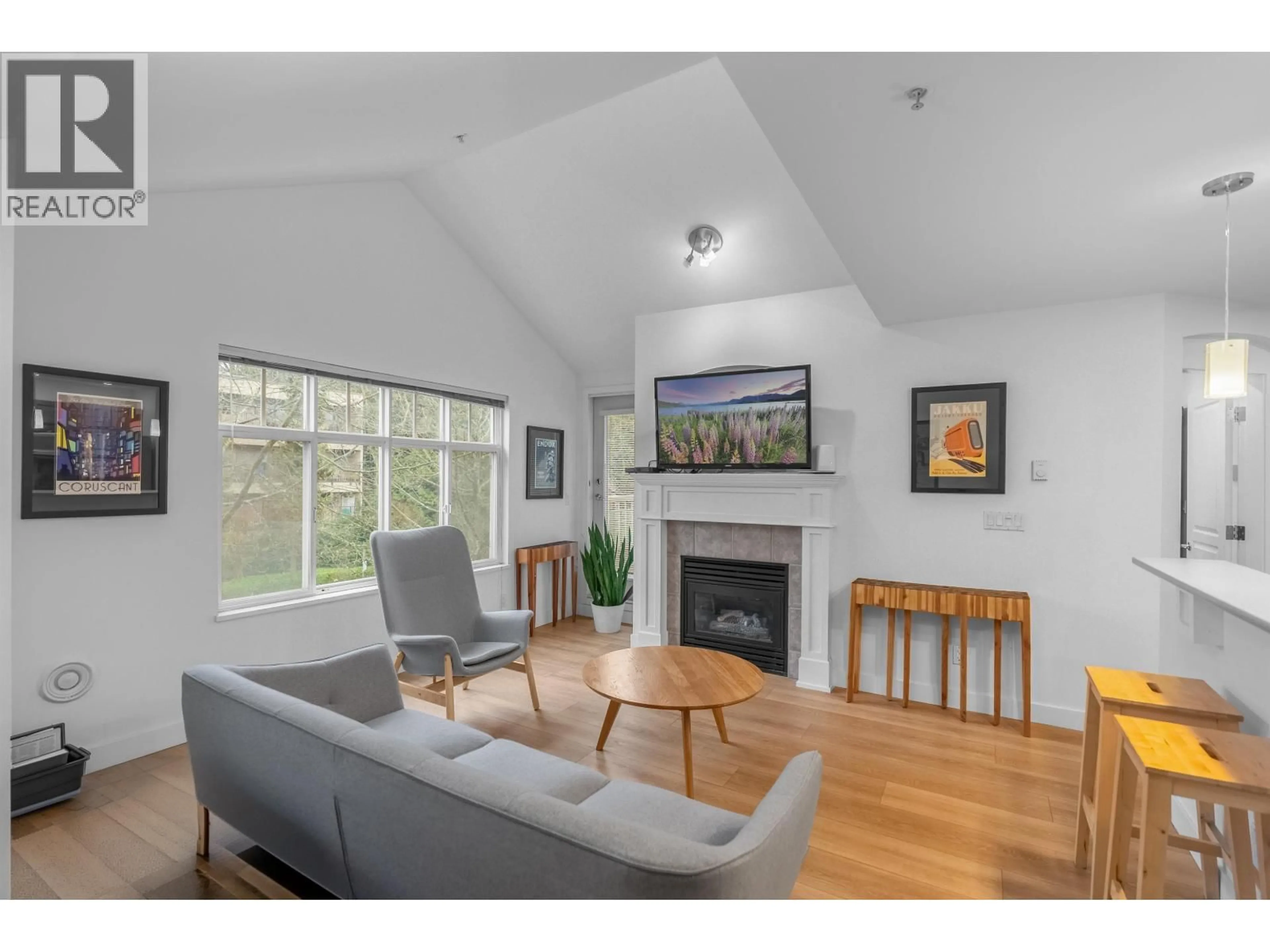 Living room with furniture, wood/laminate floor for 302 - 333 1ST STREET, North Vancouver British Columbia V7L4W9