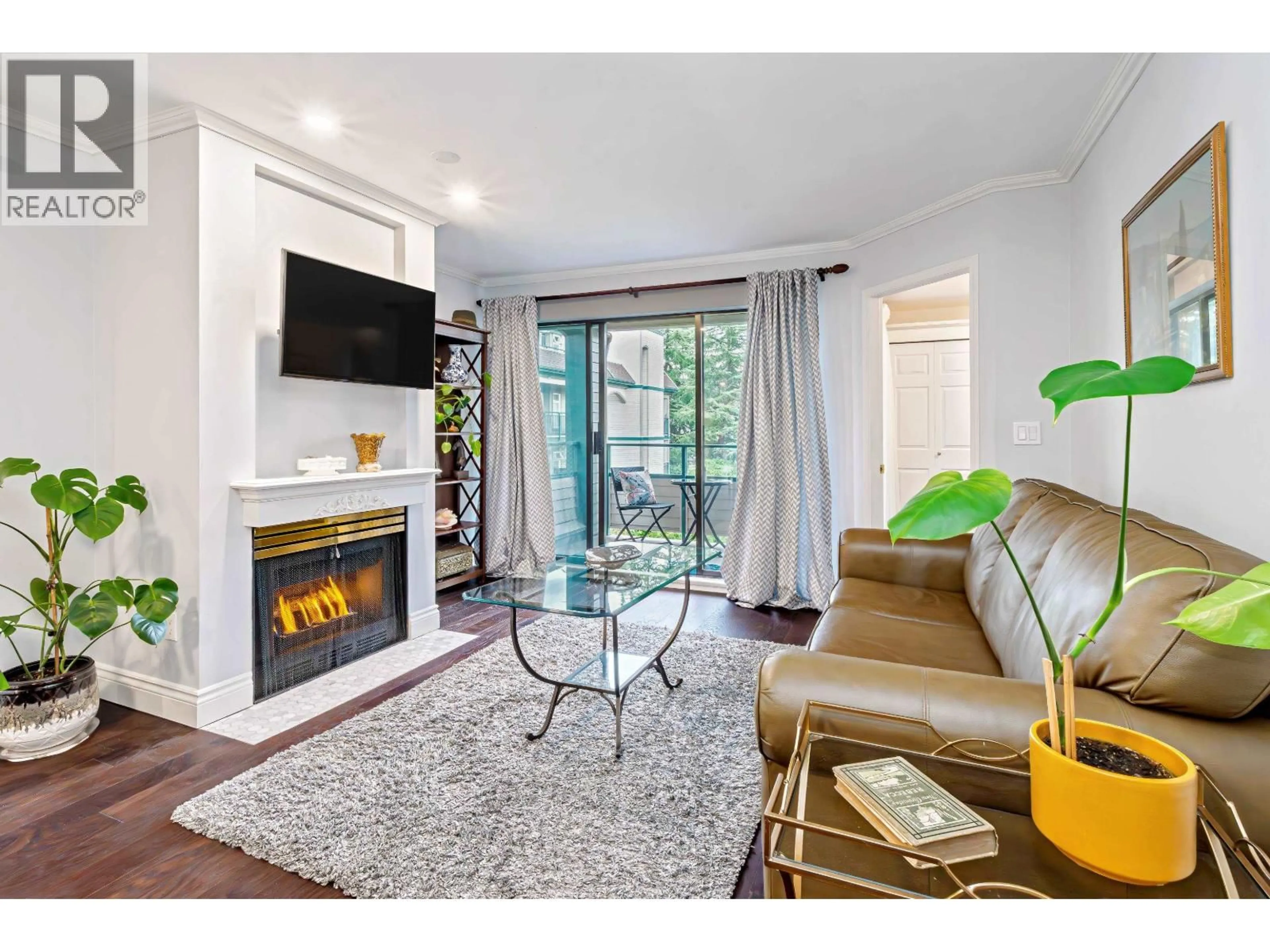 Living room with furniture, wood/laminate floor for 305 - 2925 GLEN DRIVE, Coquitlam British Columbia V3B7H9