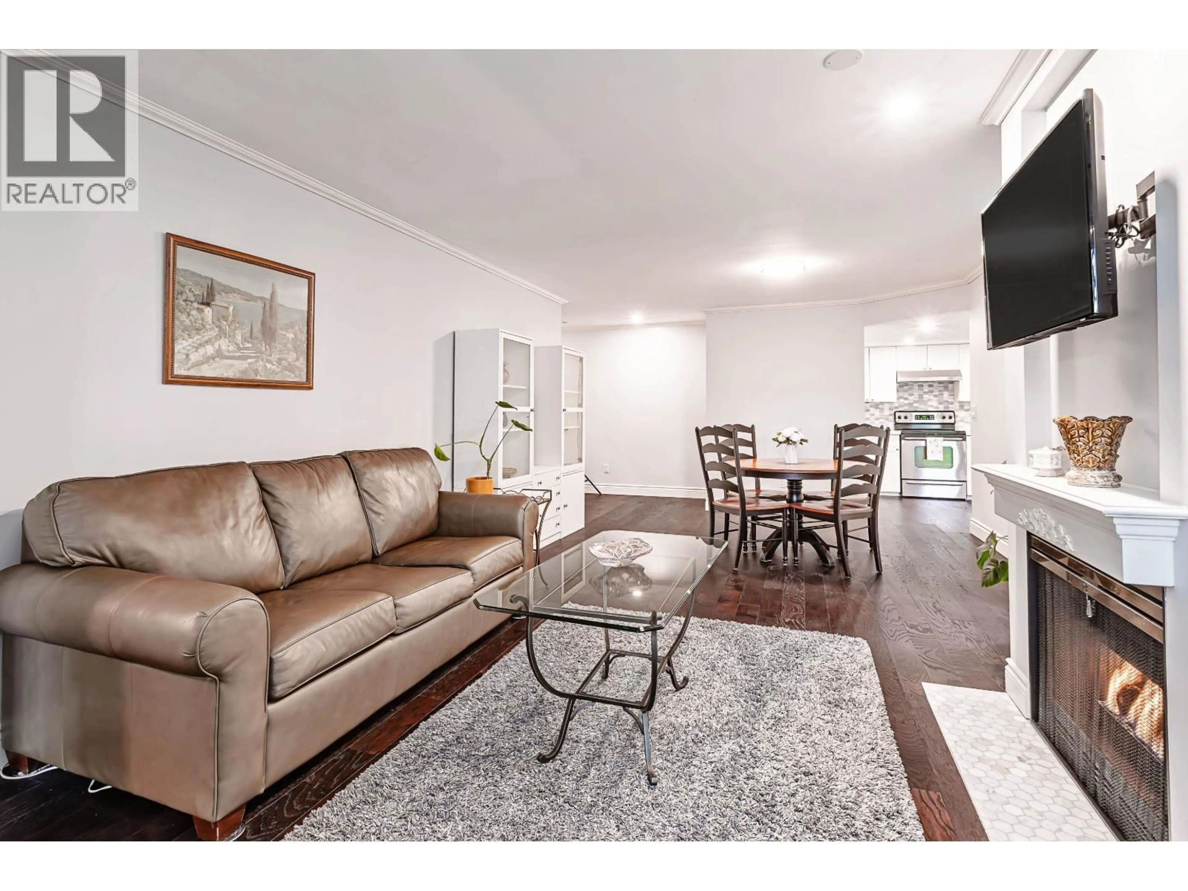 Living room with furniture, wood/laminate floor for 305 - 2925 GLEN DRIVE, Coquitlam British Columbia V3B7H9