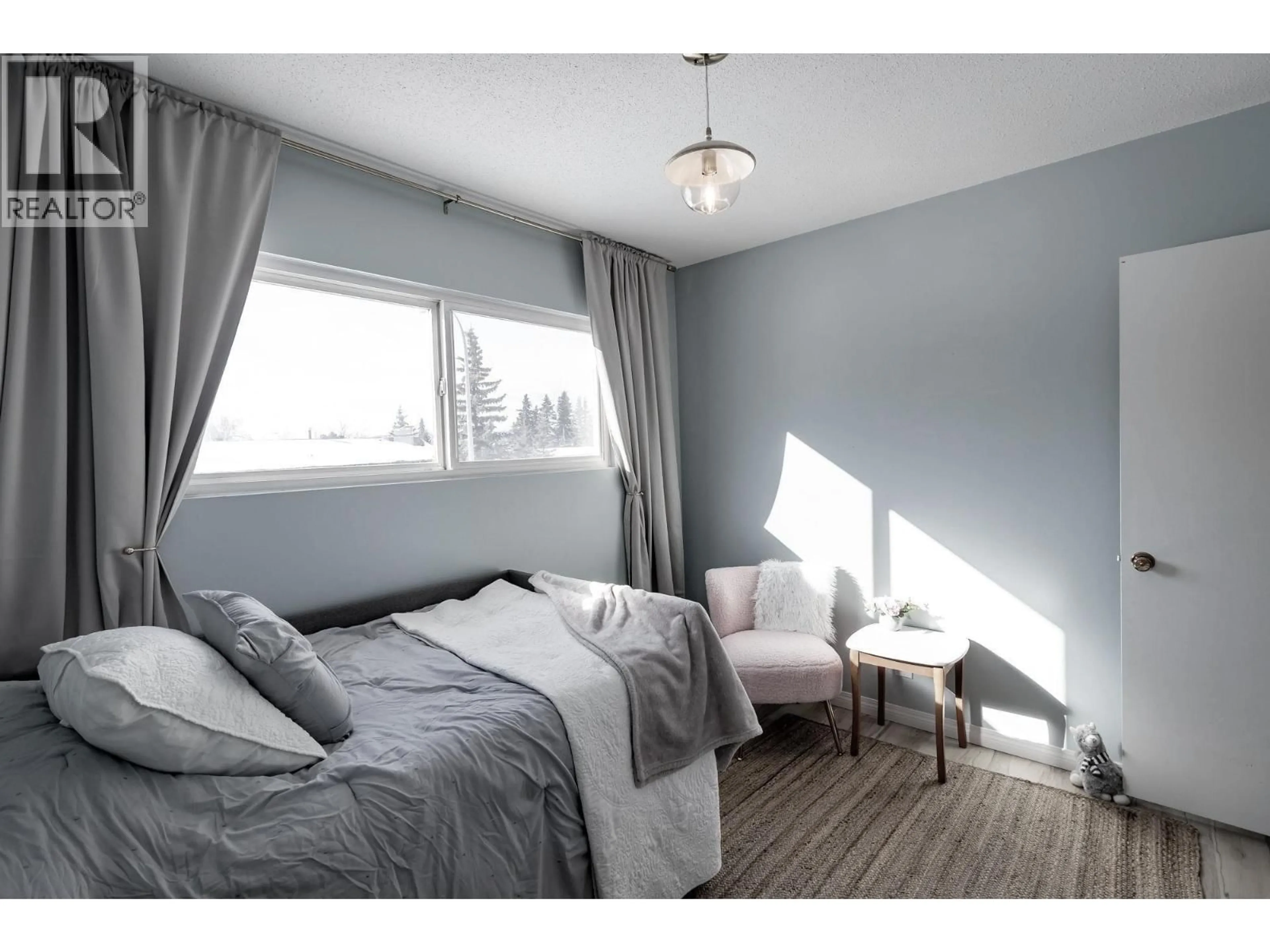 Bedroom with bed, wood/laminate floor for 11323 94 STREET, Fort St. John British Columbia V1J3M1