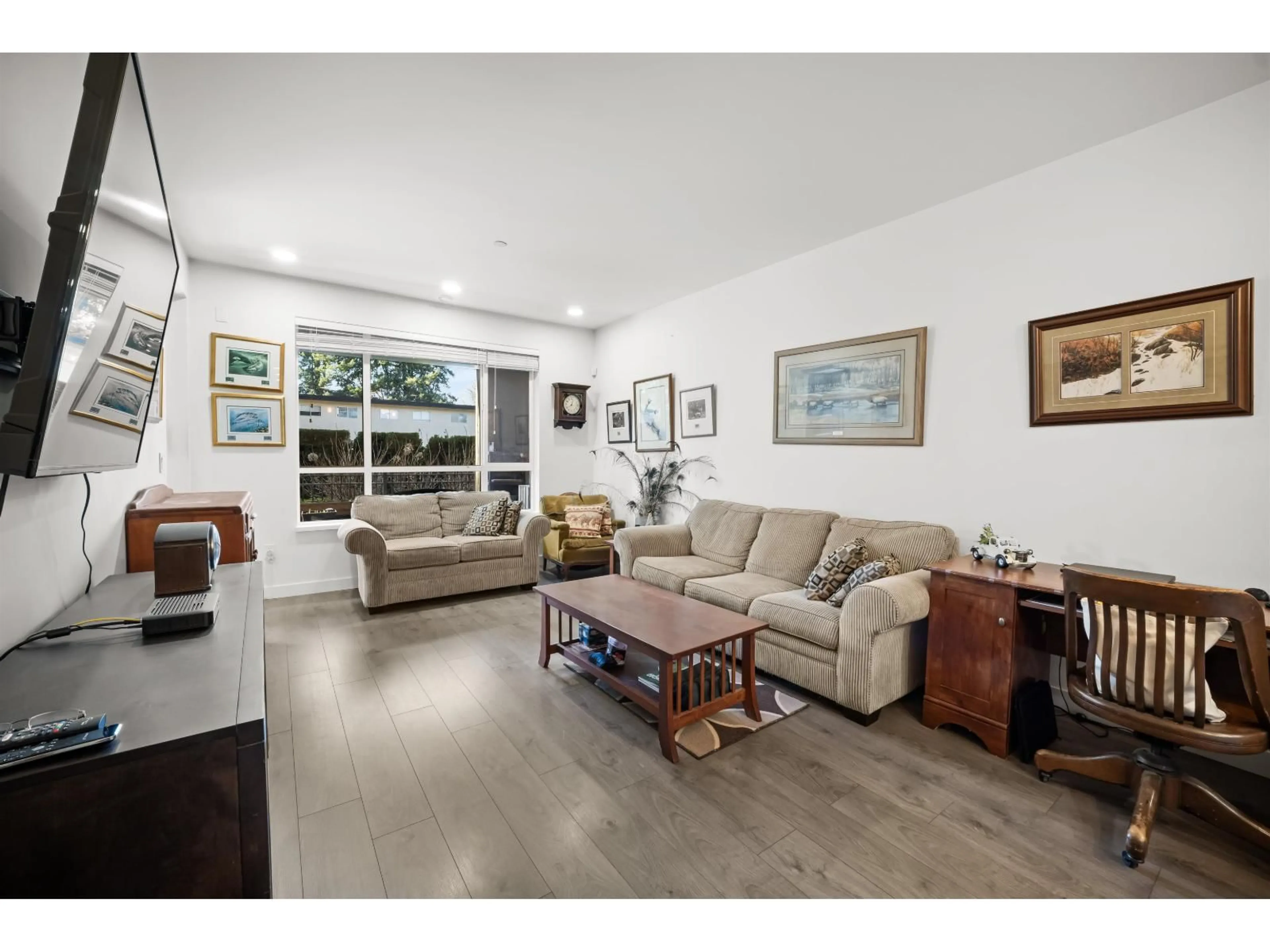 Living room with furniture, wood/laminate floor for 105 - 33540 MAYFAIR AVENUE, Abbotsford British Columbia V2S0J3