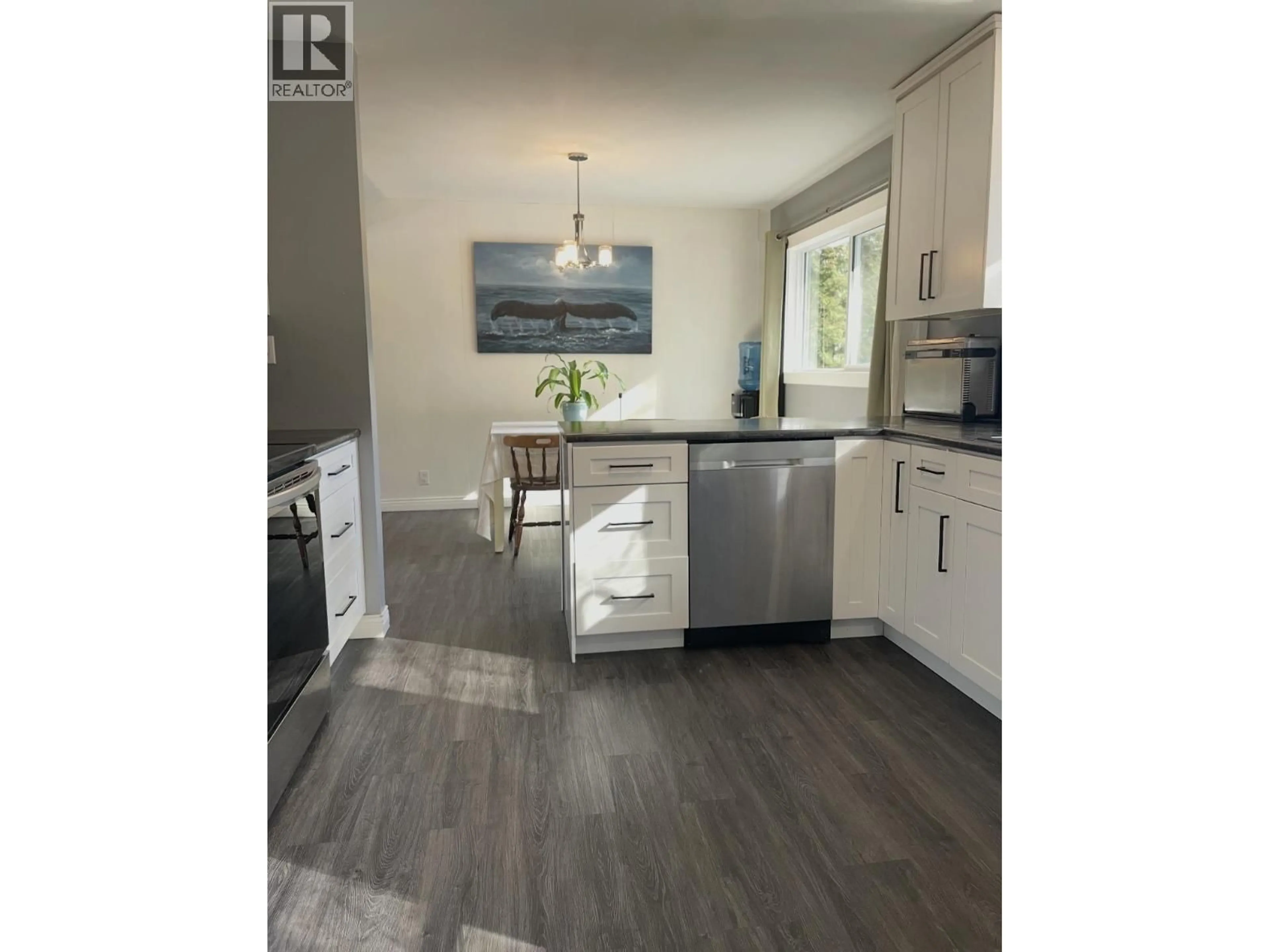 Open concept kitchen, wood/laminate floor for A - 4907 MILLS AVENUE, Terrace British Columbia V8G1C3