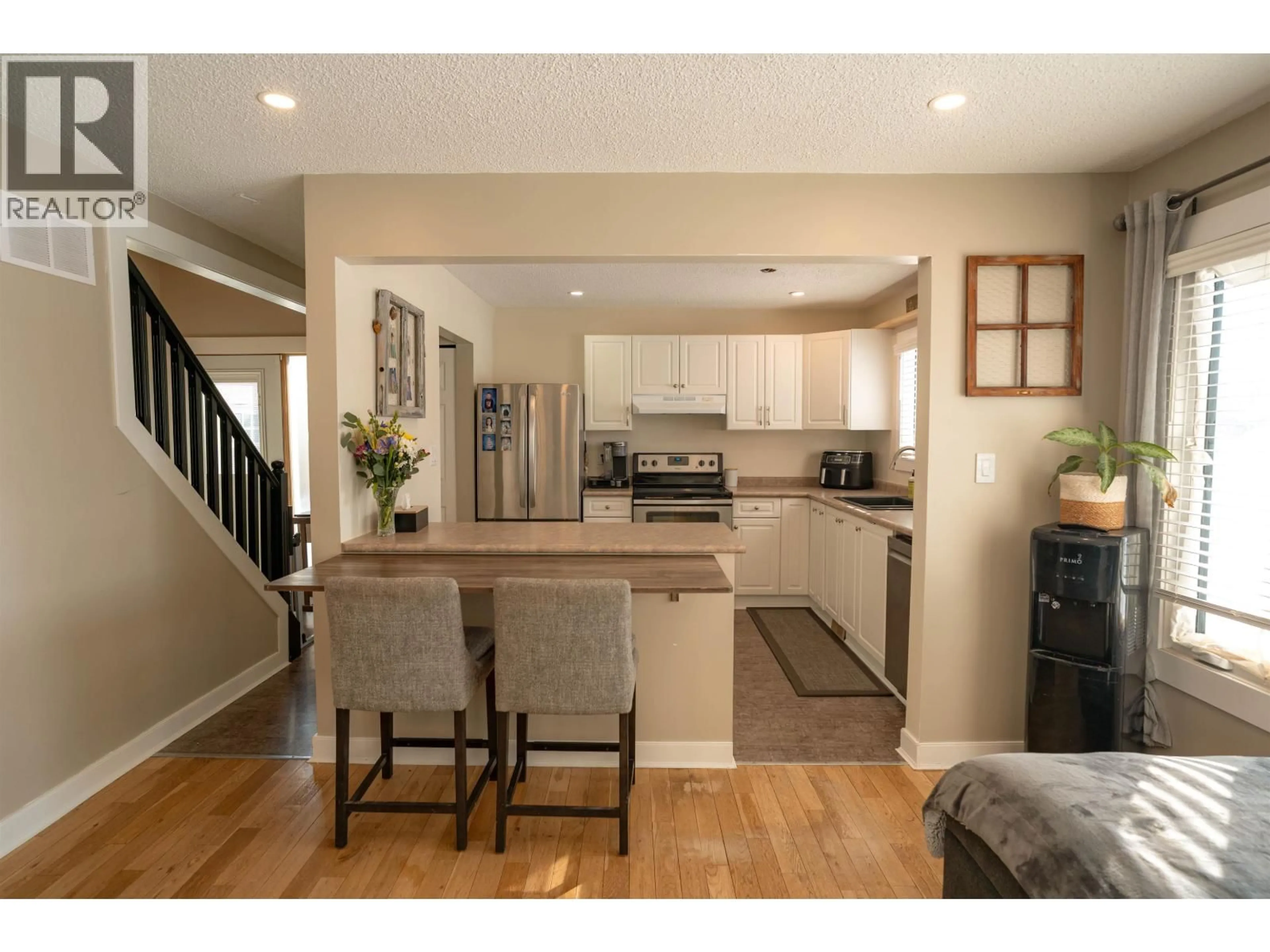 Open concept kitchen, wood/laminate floor for 9003 89 STREET, Fort St. John British Columbia V1J5B9