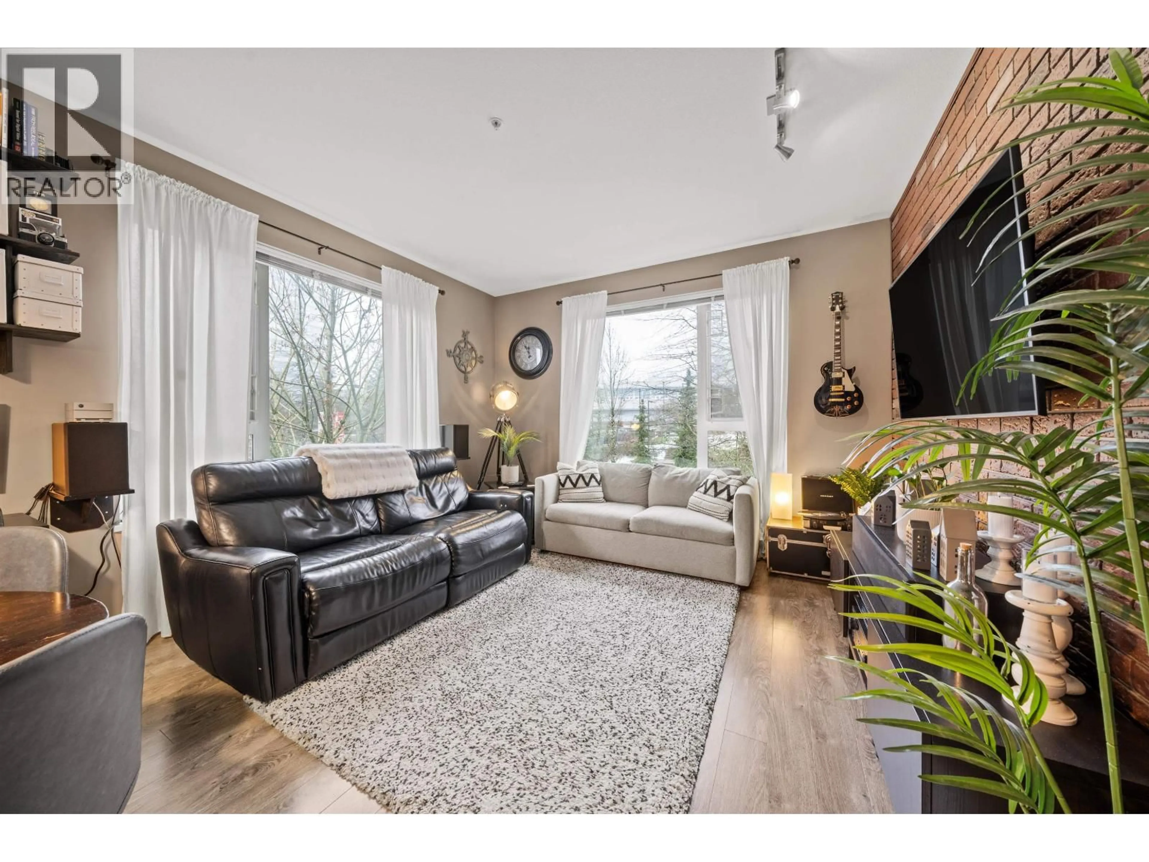 Living room with furniture, wood/laminate floor for 516 - 9250 UNIVERSITY HIGH STREET, Burnaby British Columbia V5A0B3