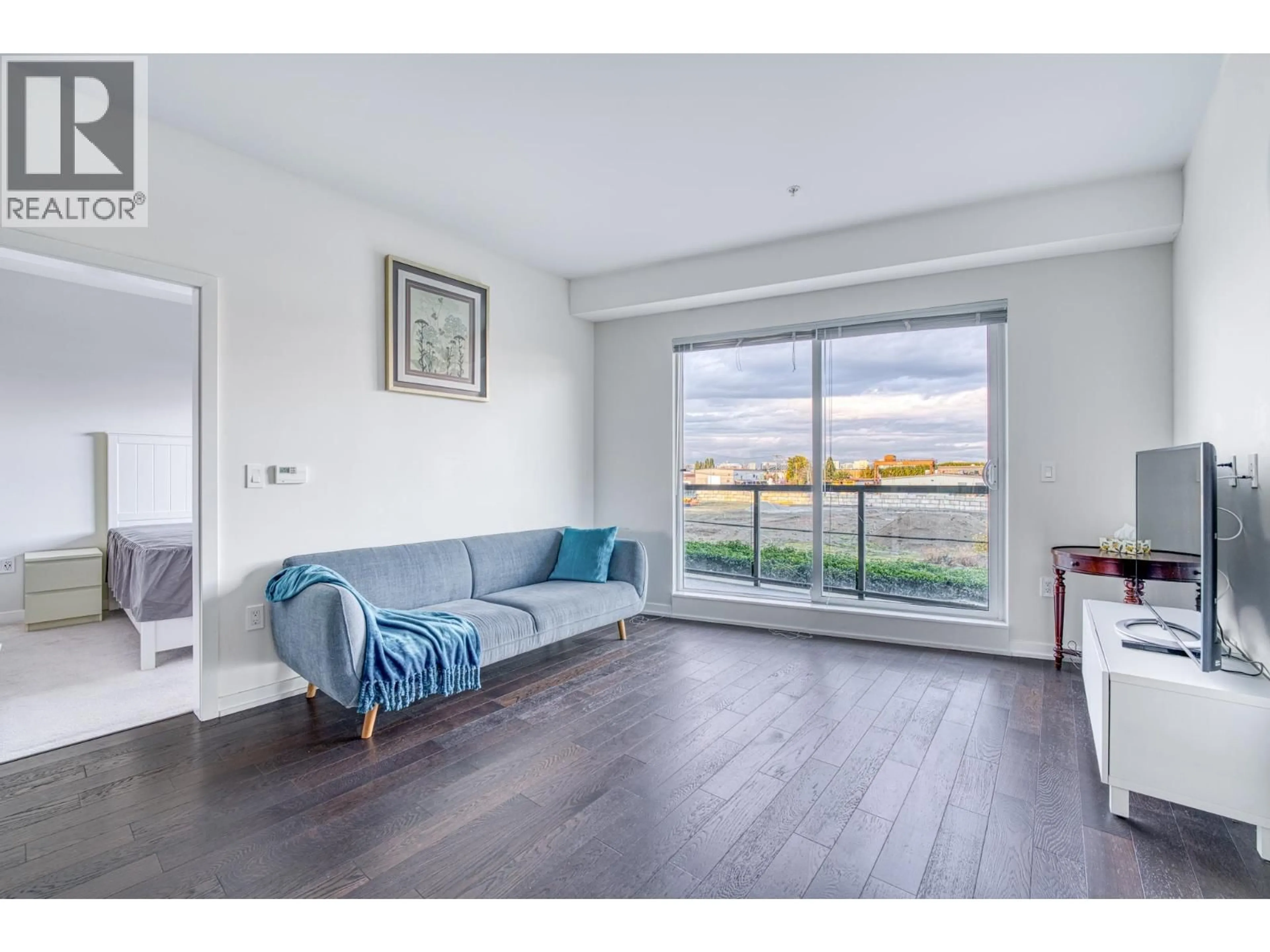 Living room with furniture, wood/laminate floor for 210 - 7008 RIVER PARKWAY, Richmond British Columbia V6X0R1