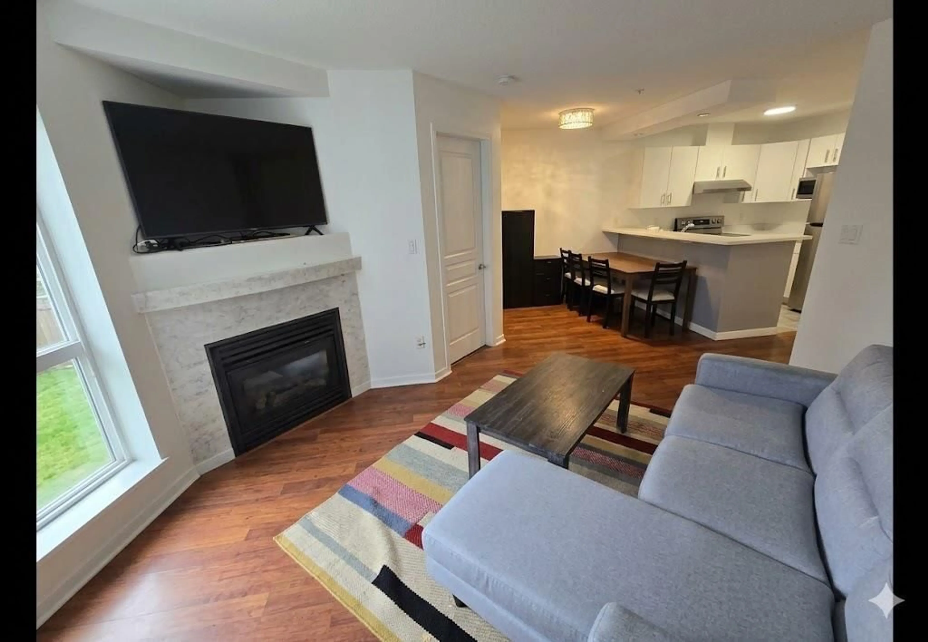 Living room with furniture, wood/laminate floor for 310 - 20200 56 AVENUE, Langley British Columbia V3A8S1