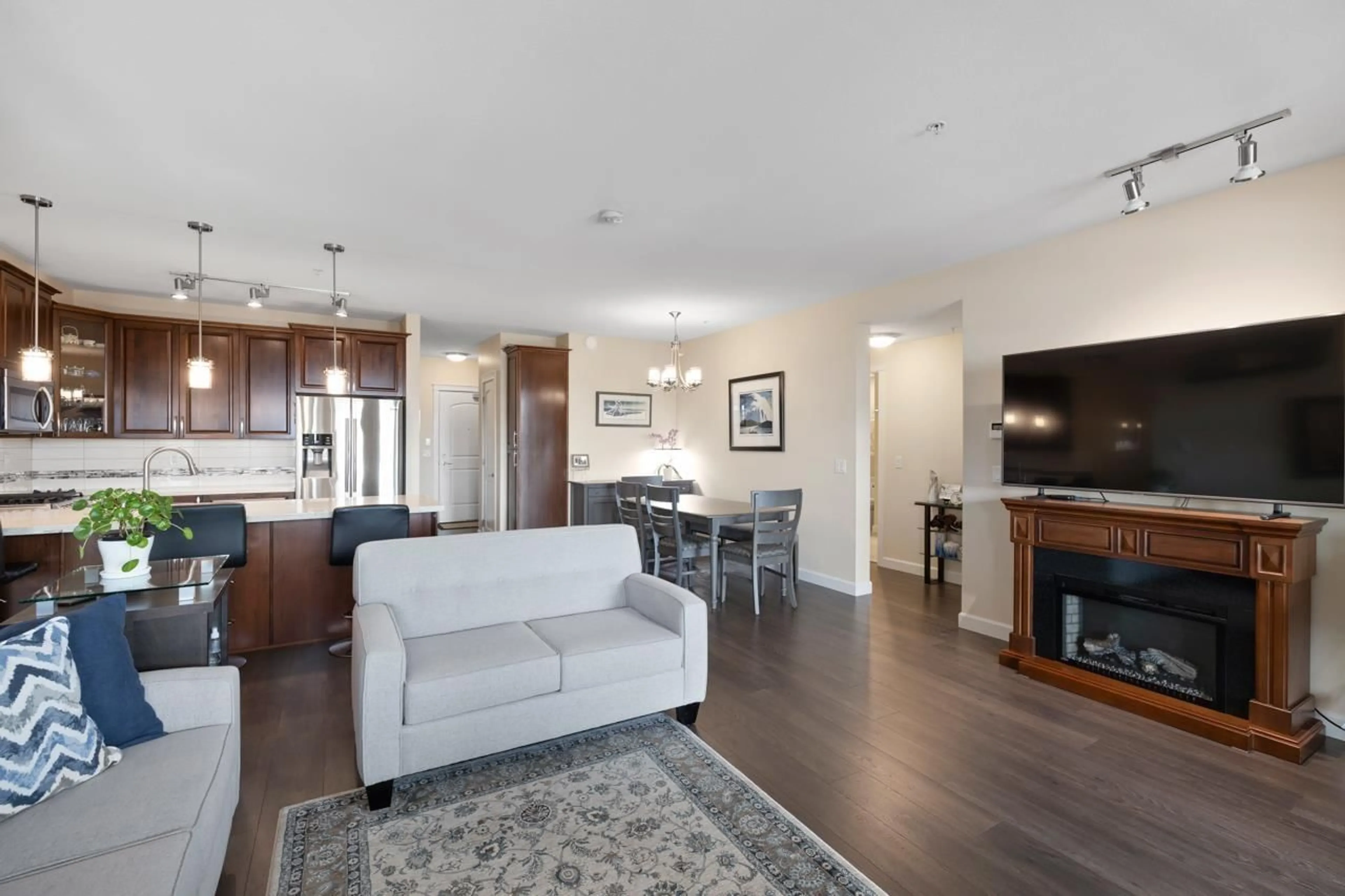 Living room with furniture, wood/laminate floor for A510 - 20716 WILLOUGHBY TOWN CENTRE DRIVE, Langley British Columbia V2Y3J7