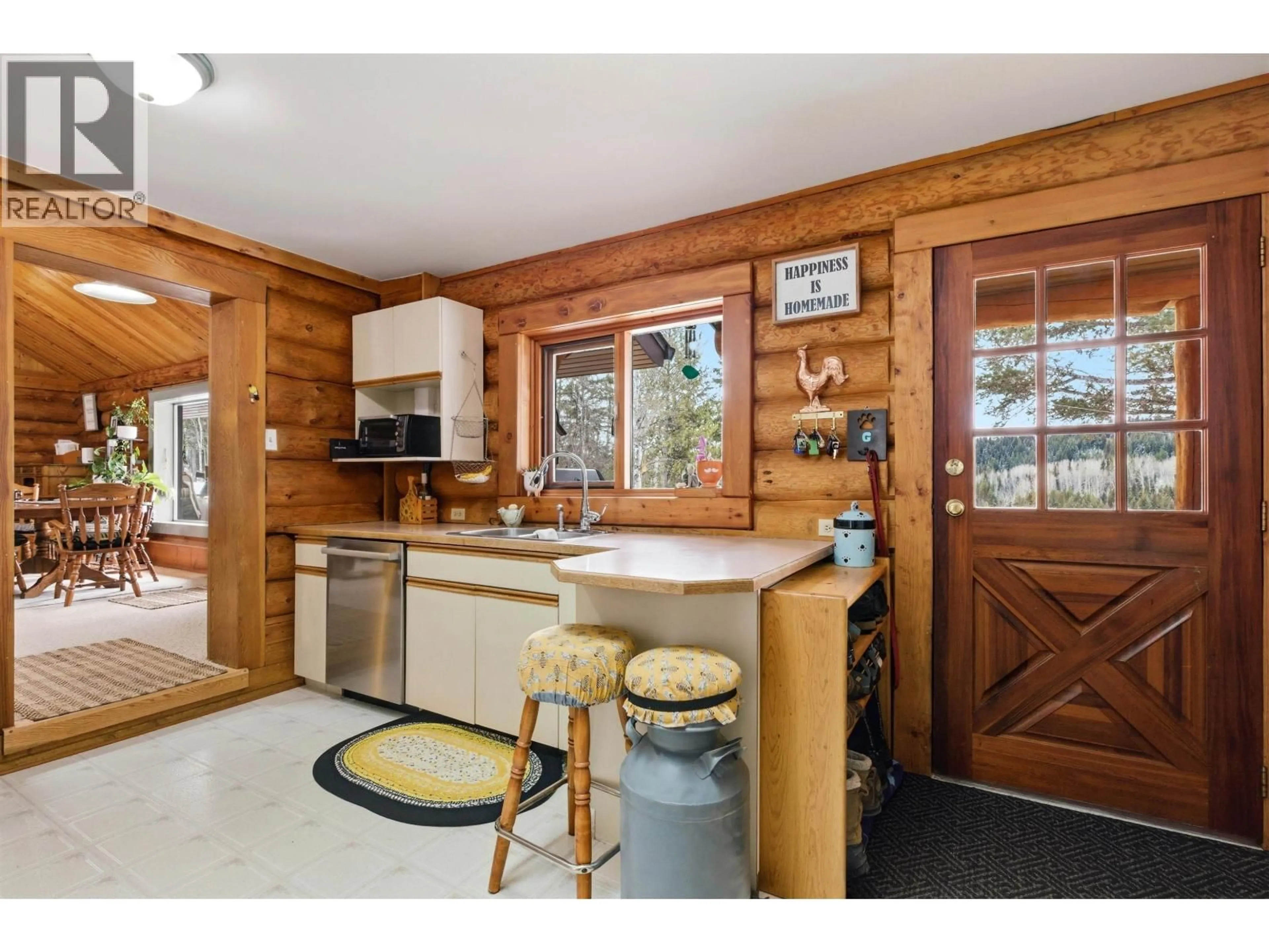 Open concept kitchen, wood/laminate floor for 2815 PIONEER CRESCENT, 150 Mile House British Columbia V0K2G0