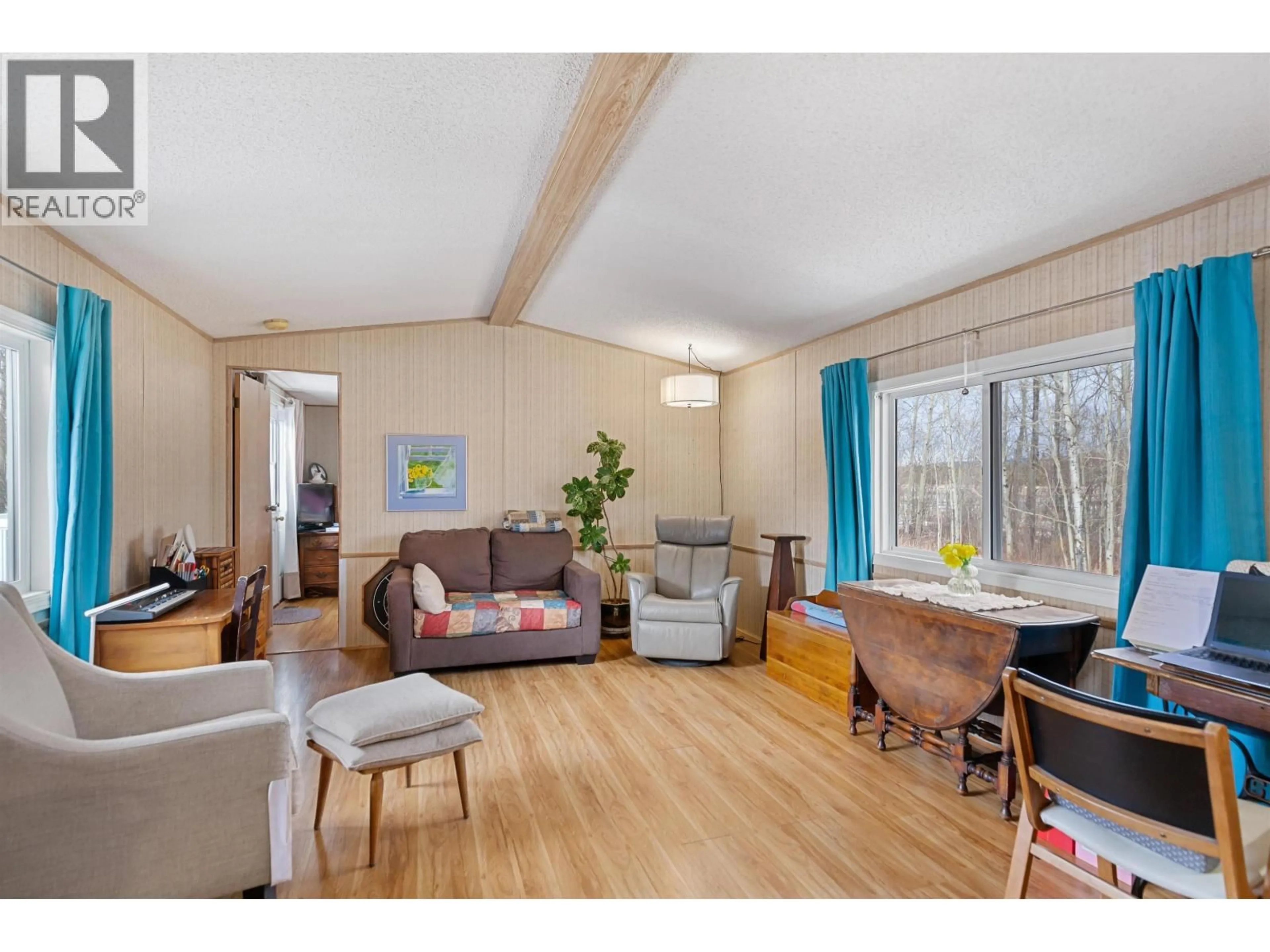 Living room with furniture, wood/laminate floor for 9645 POOLEY ROAD, Prince George British Columbia V2N5V5
