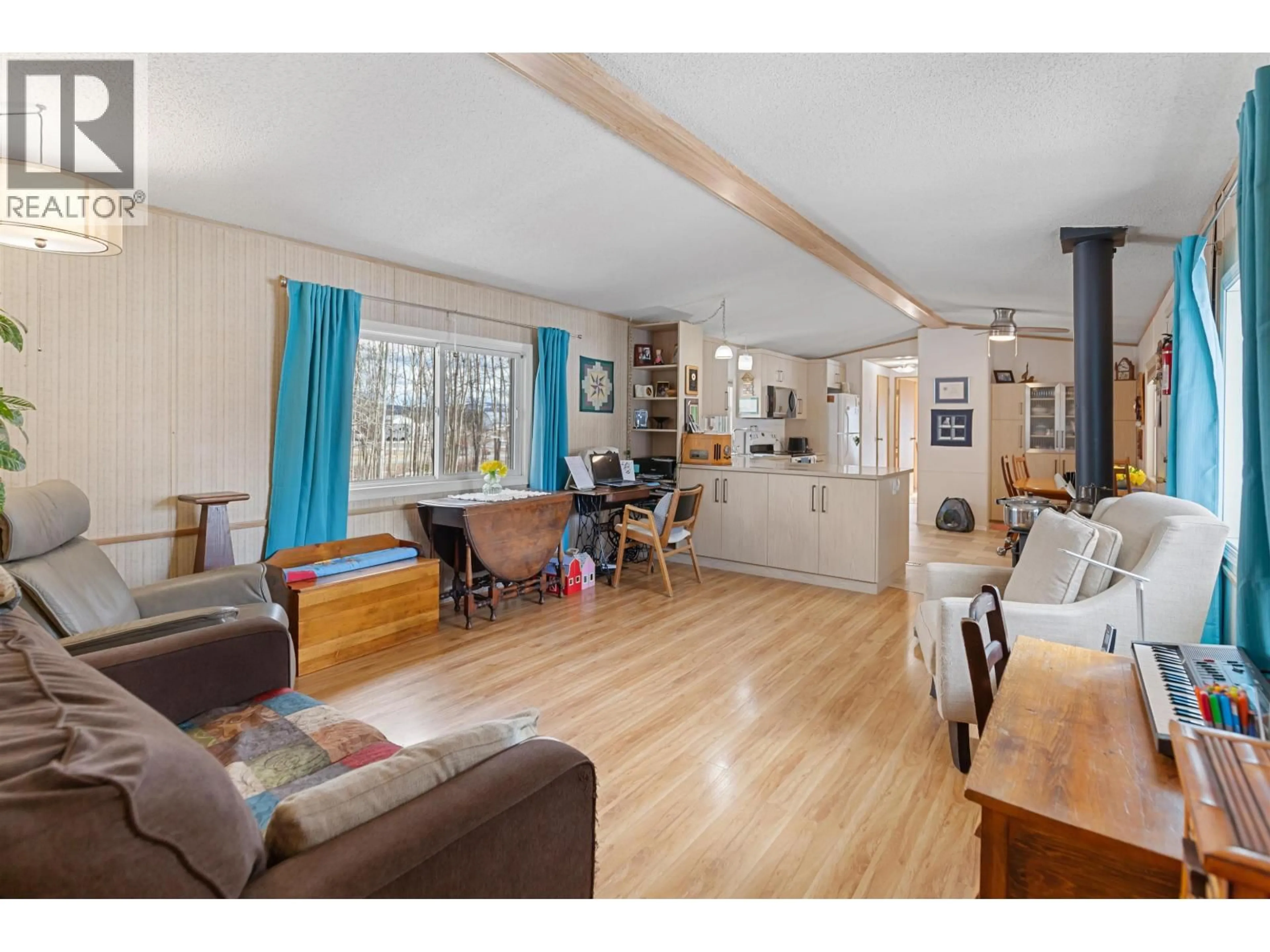 Living room with furniture, wood/laminate floor for 9645 POOLEY ROAD, Prince George British Columbia V2N5V5