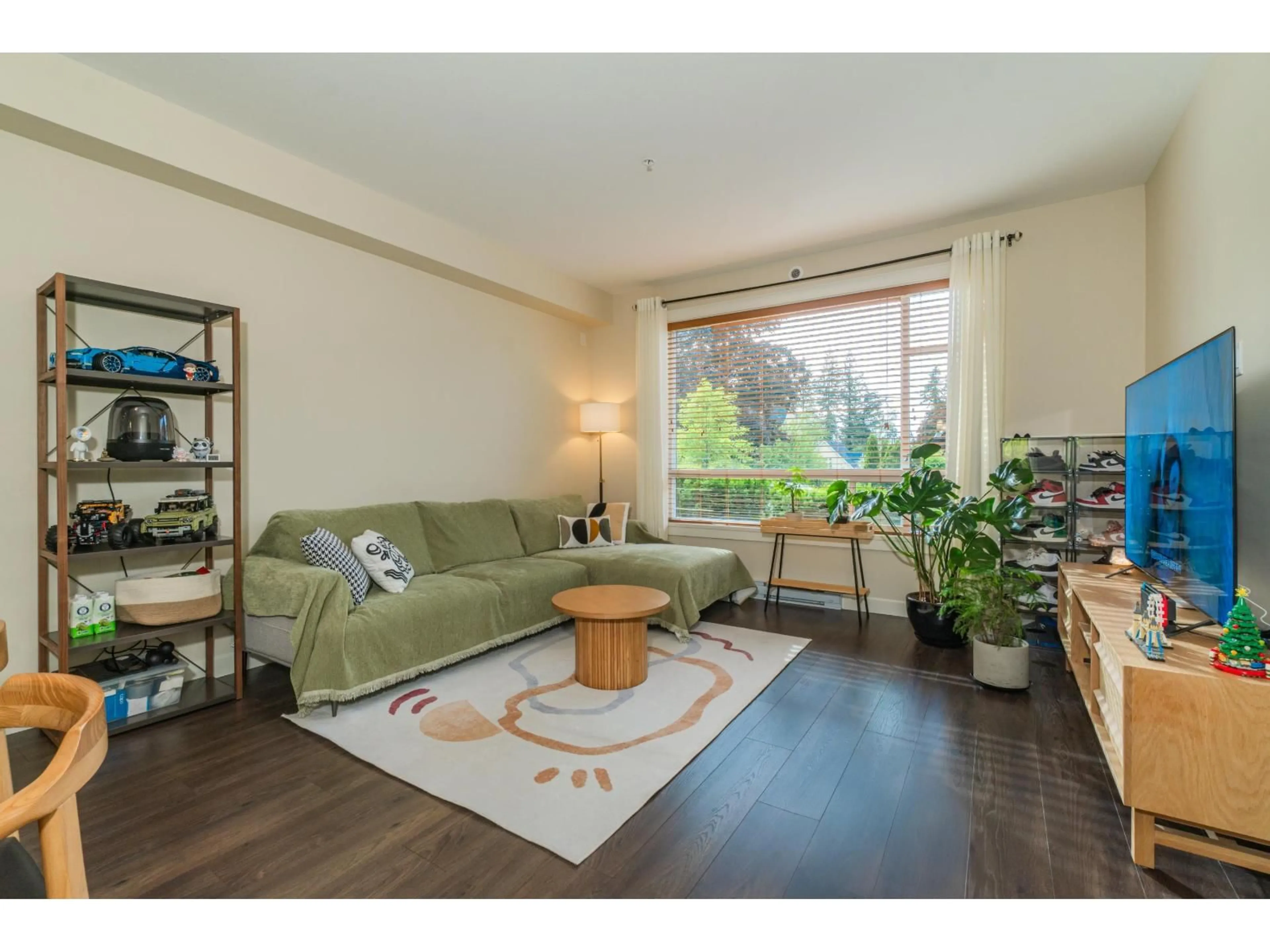 Living room with furniture, wood/laminate floor for 103 - 14588 MCDOUGALL DRIVE, Surrey British Columbia V4P0H1
