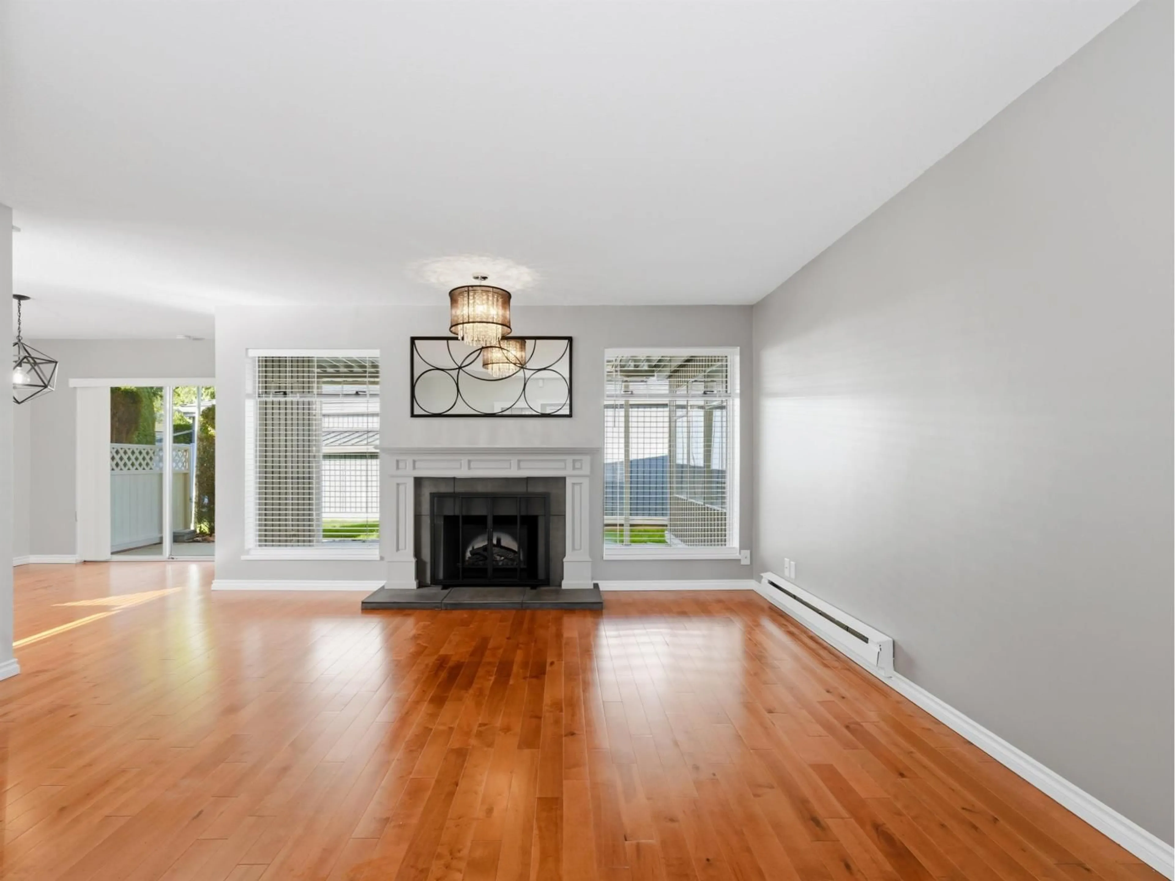 Living room with furniture, wood/laminate floor for 113 - 14271 18A AVENUE, Surrey British Columbia V4A7N8